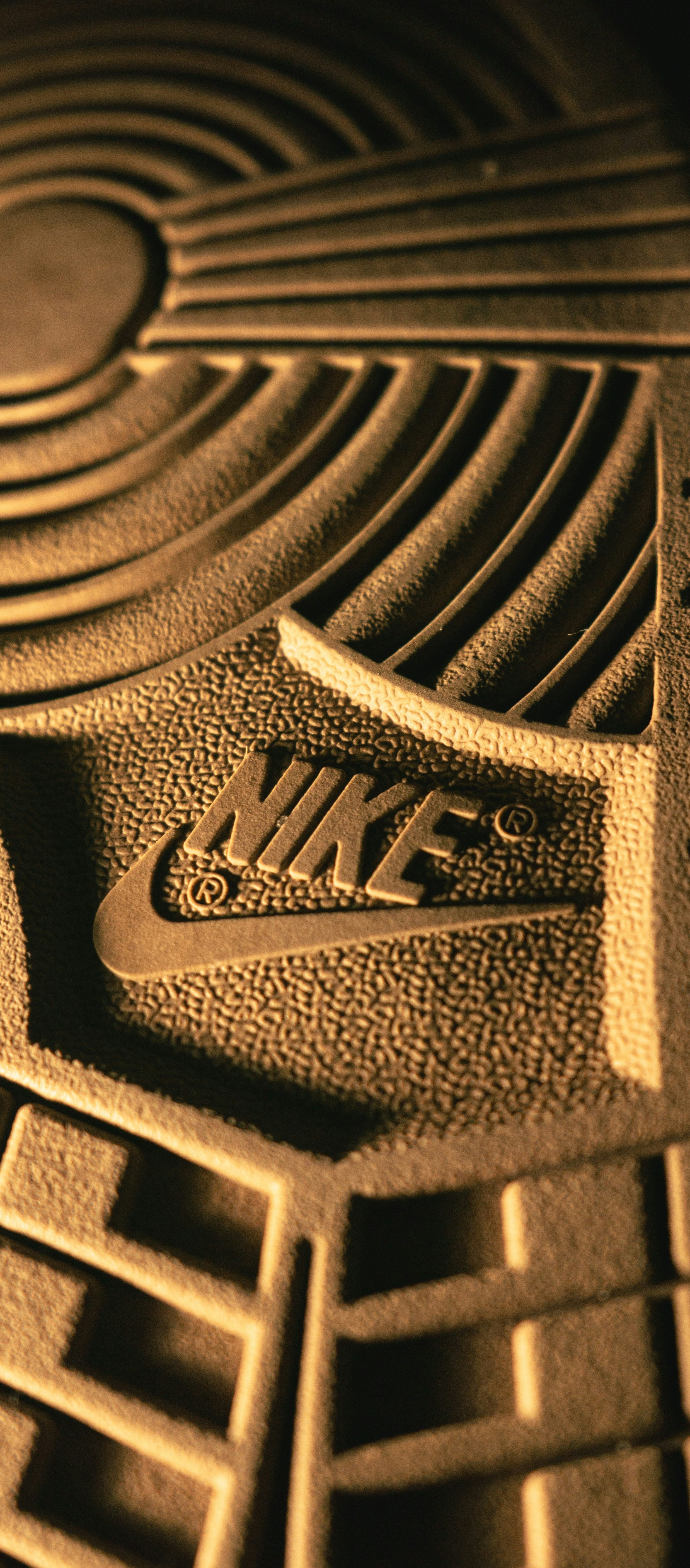 The Nike logo embossed on the textured rubber sole of a sneaker