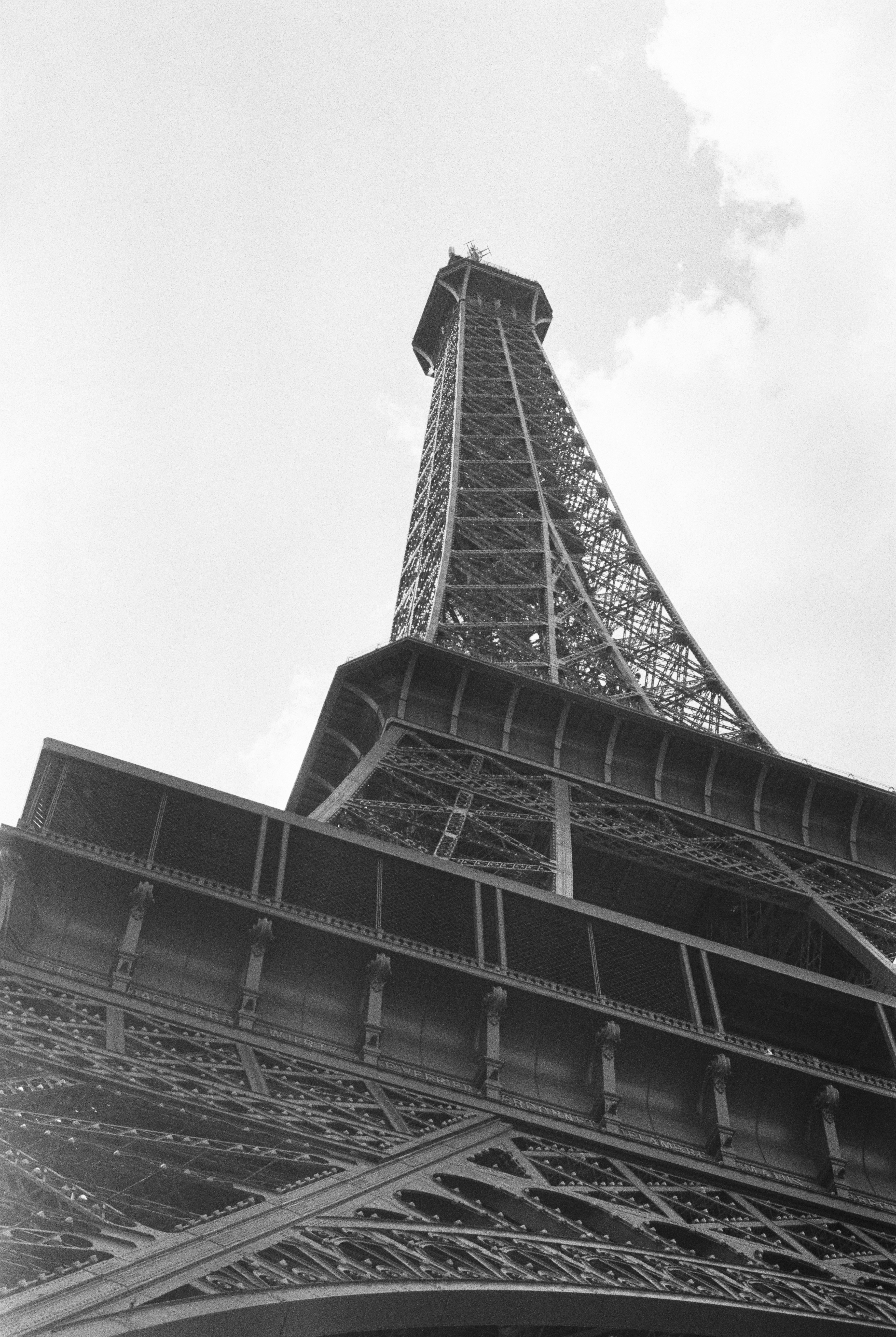 Low angle view of the Eiffel Tower in Paris against a cloudy sky