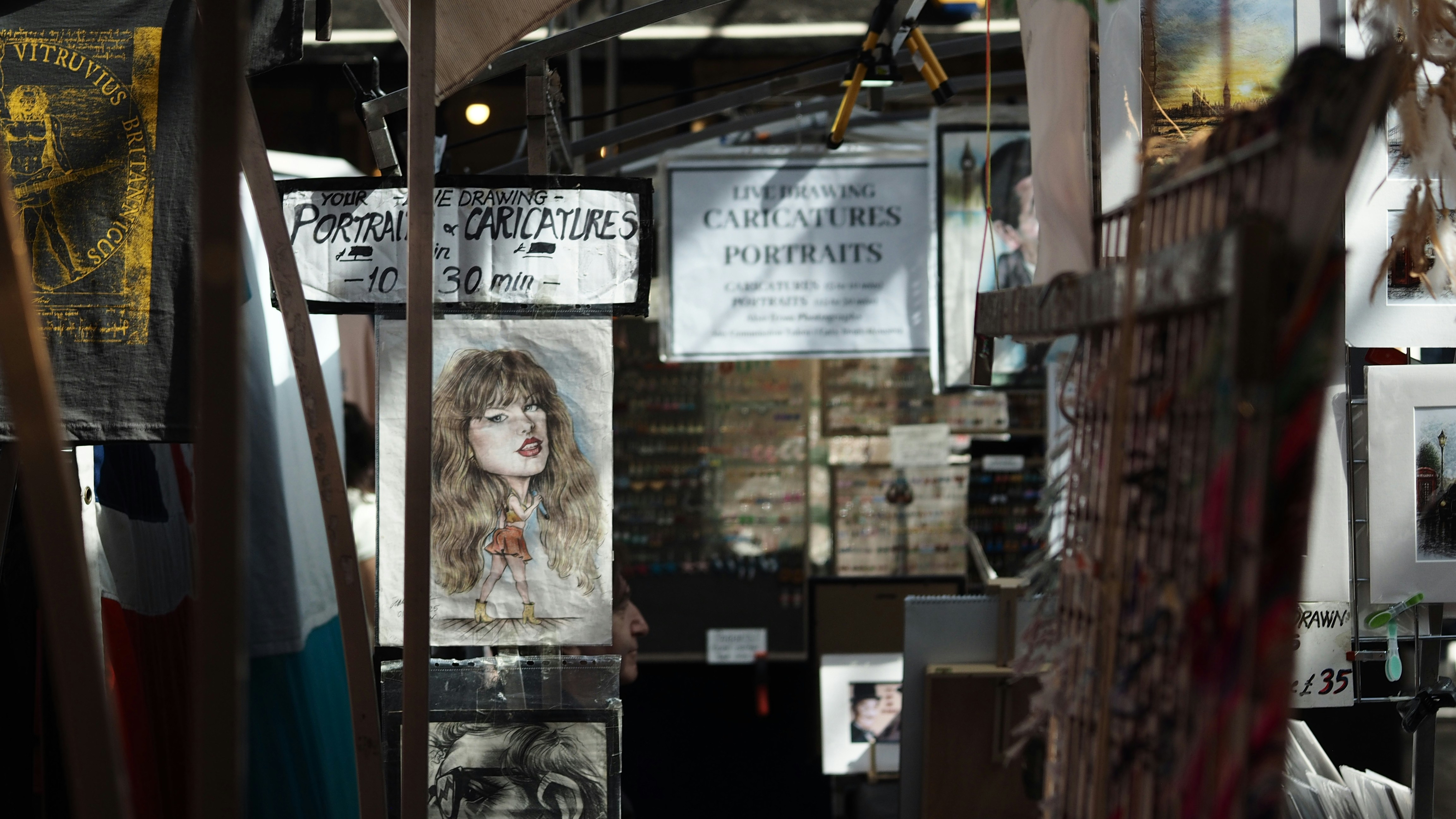 A caricature drawing of a woman displayed at an outdoor market stall