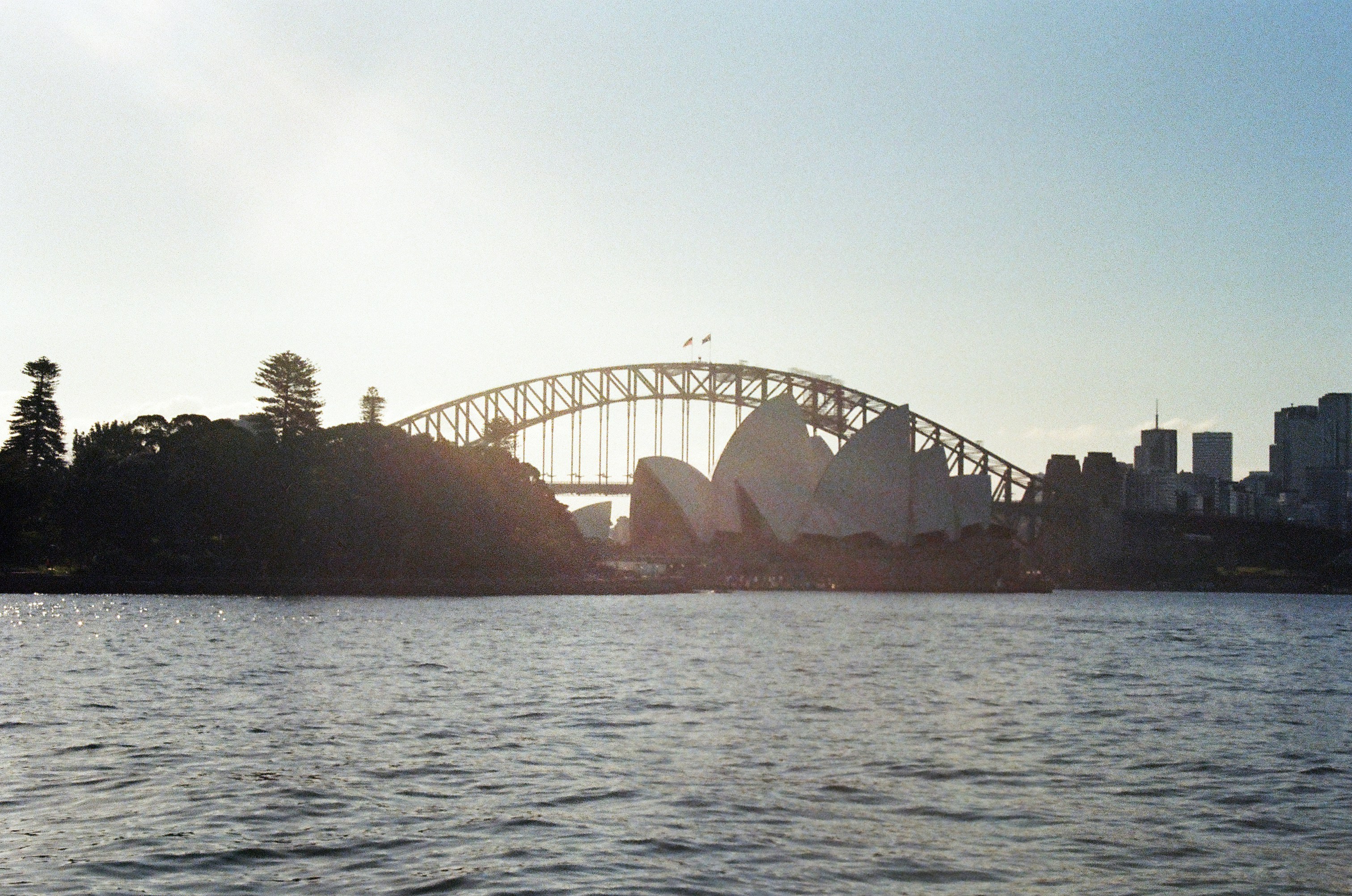 The Sydney Opera House and Harbour Bridge across the water in Sydney, Australia