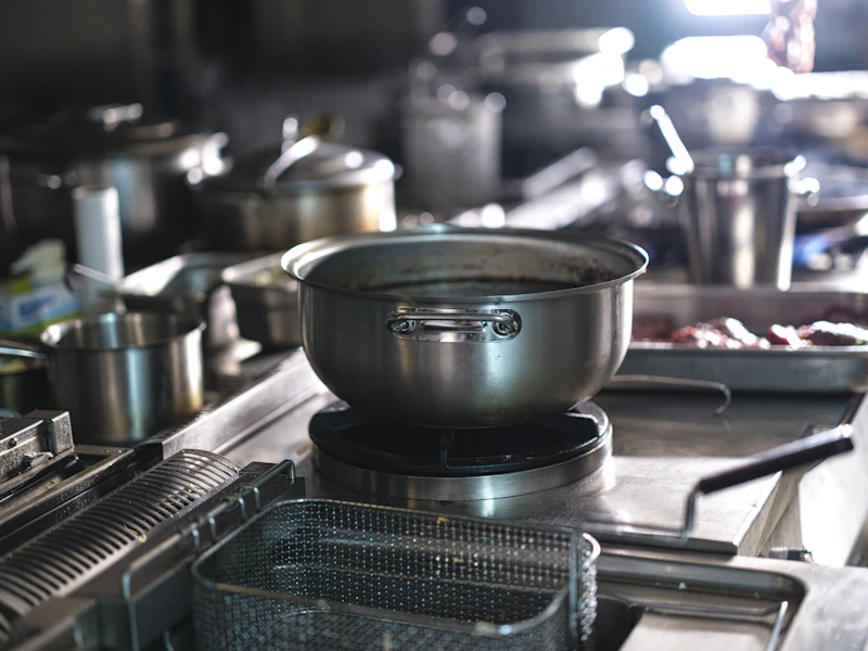 Stainless steel pots on a commercial kitchen stove
