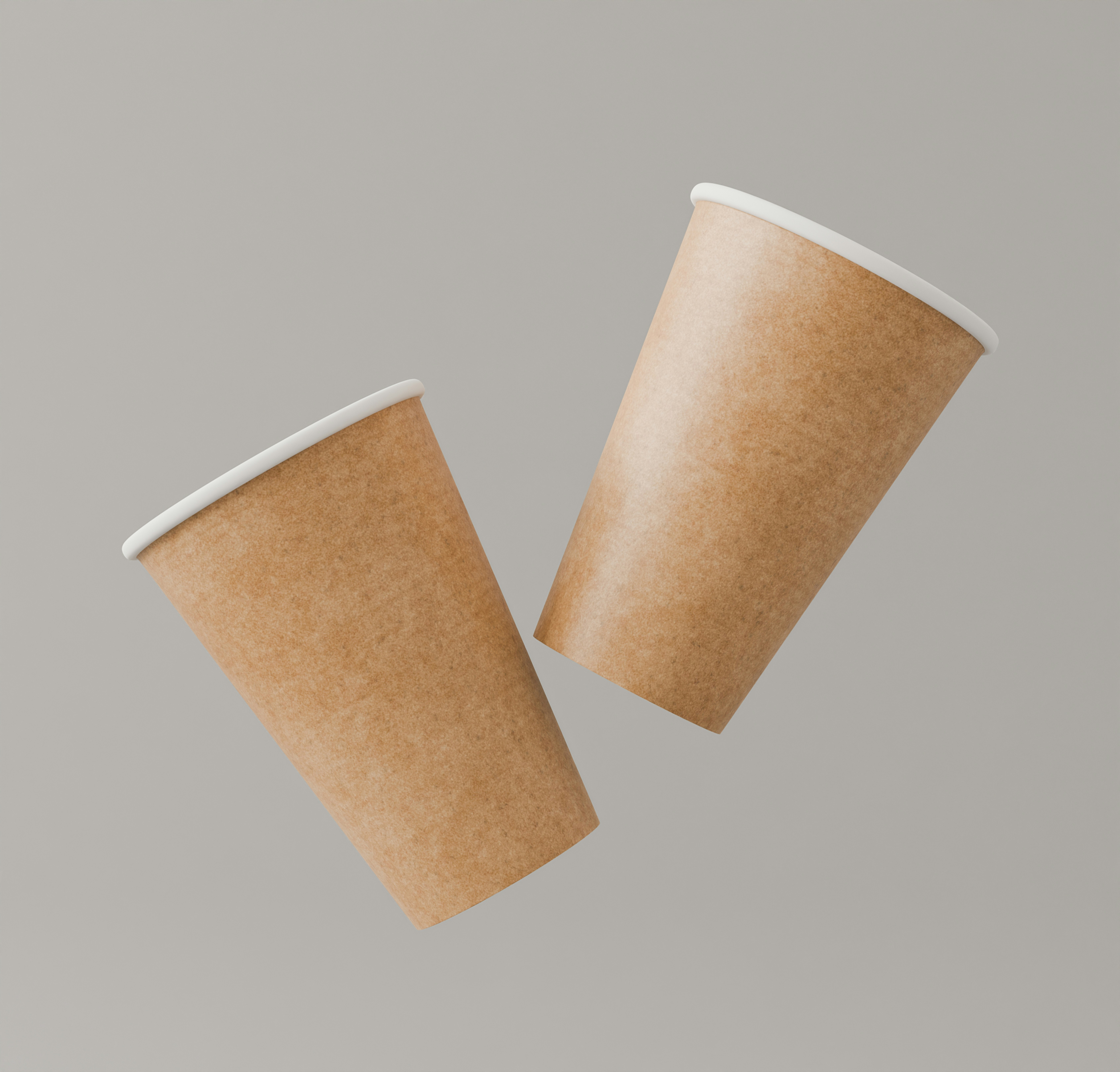 Two brown paper coffee cups floating against a plain grey background