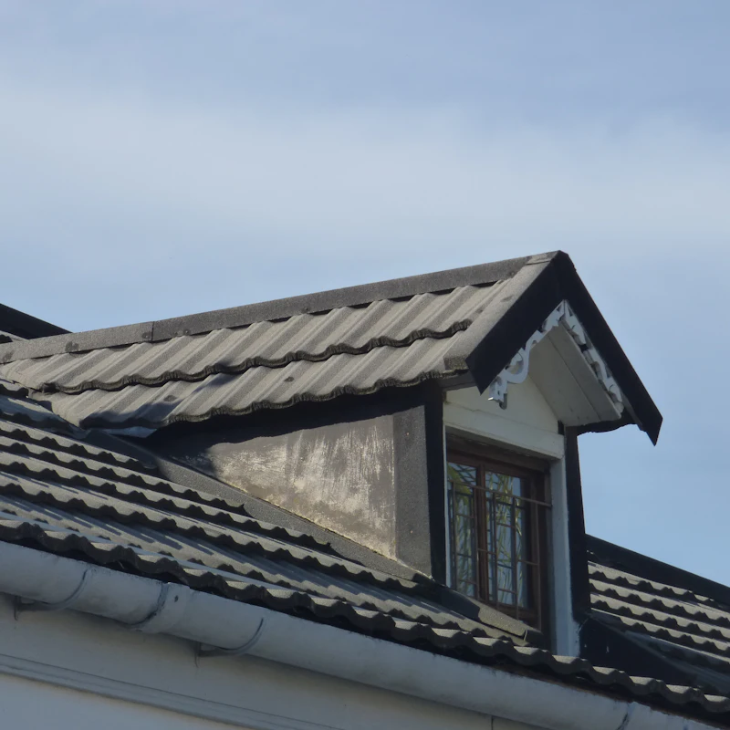 Dormer window on a grey tiled roof