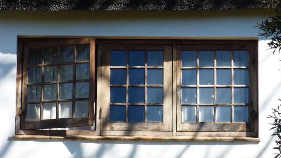 Wooden window with several panes on a white wall