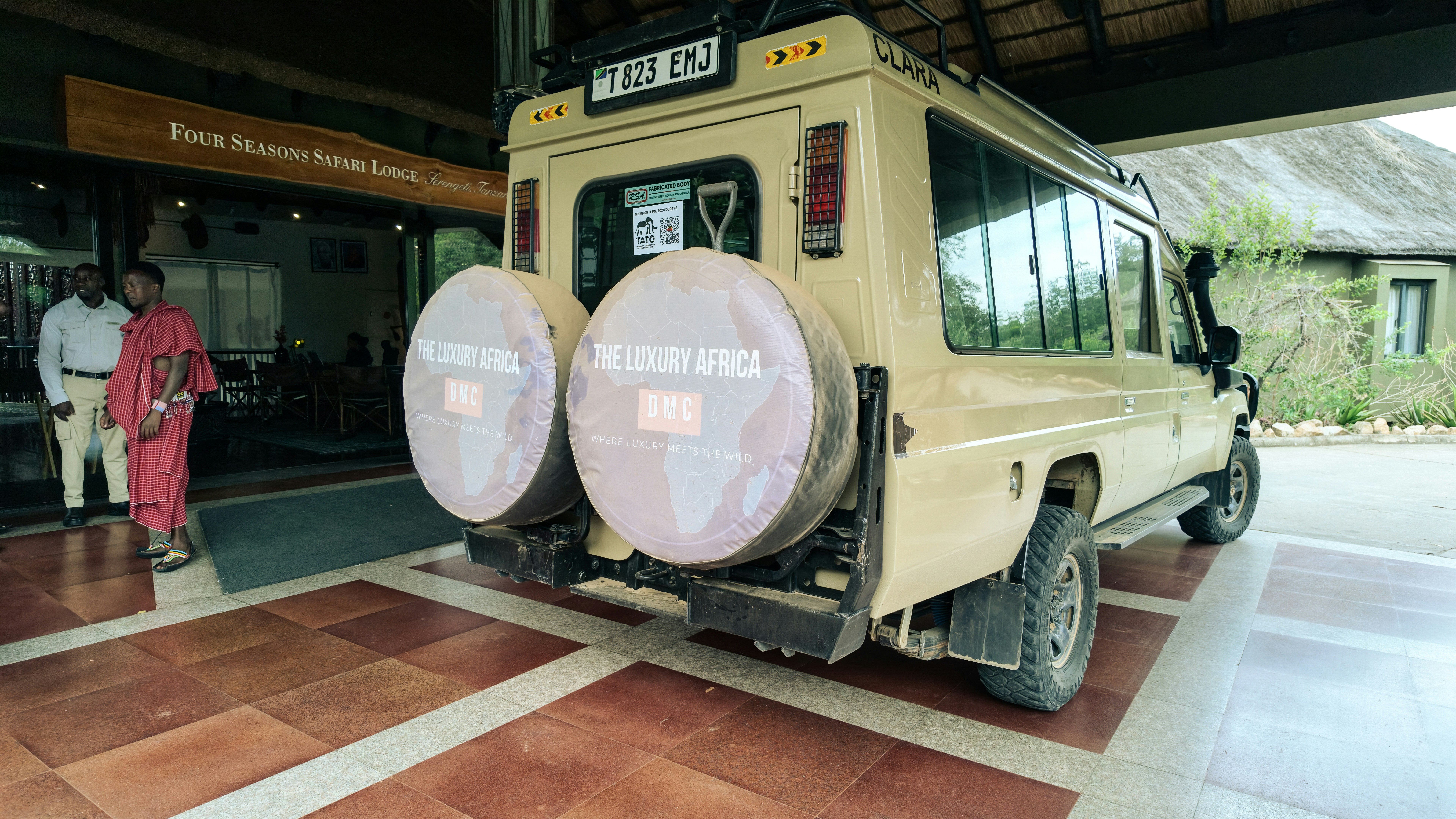 A tan safari vehicle parked at the Four Seasons Safari Lodge in Serengeti, Tanzania