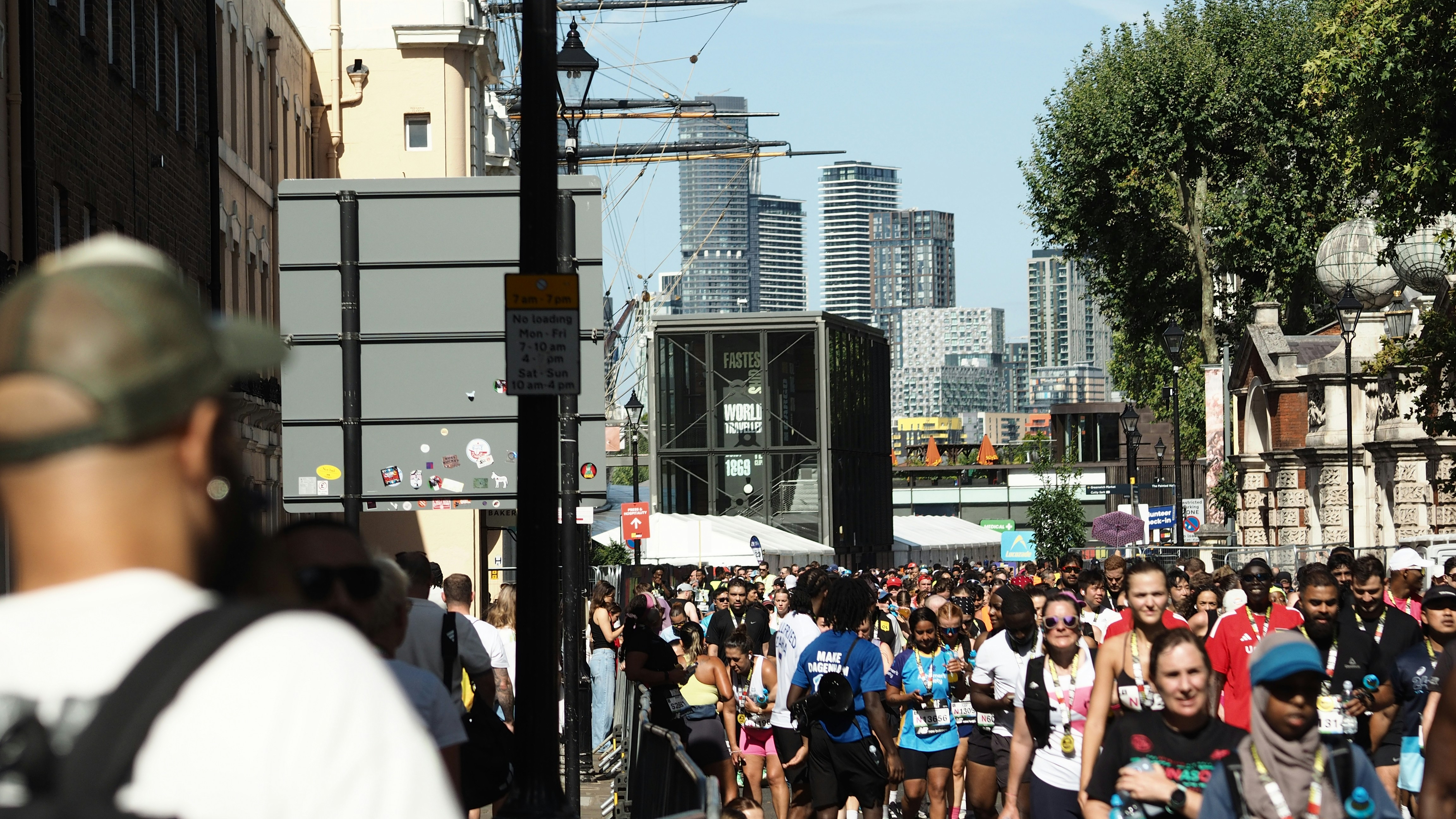 A large group of runners participating in a race on a city street