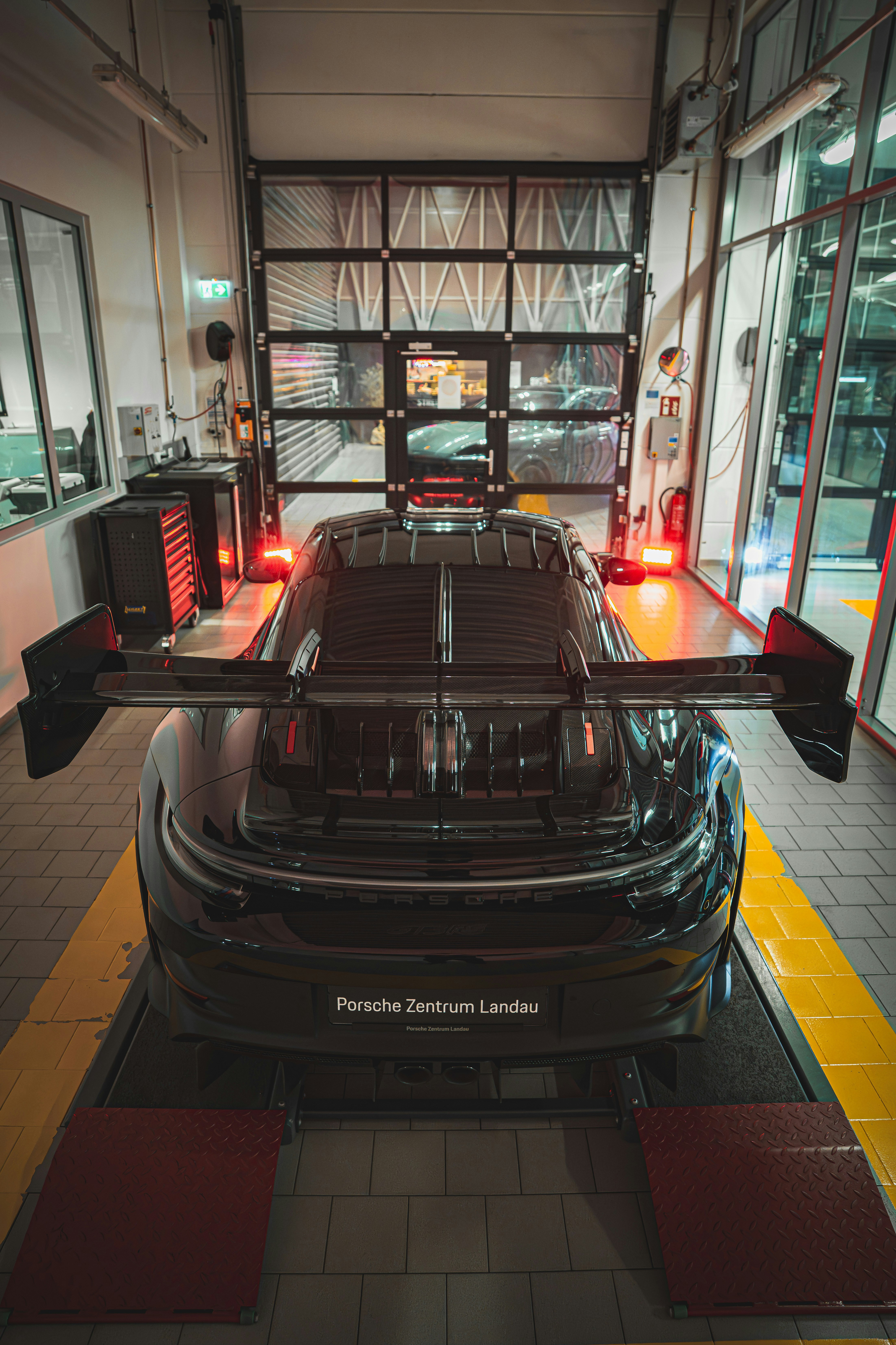 A black Porsche 911 GT3 RS in a service bay at Porsche Zentrum Landau