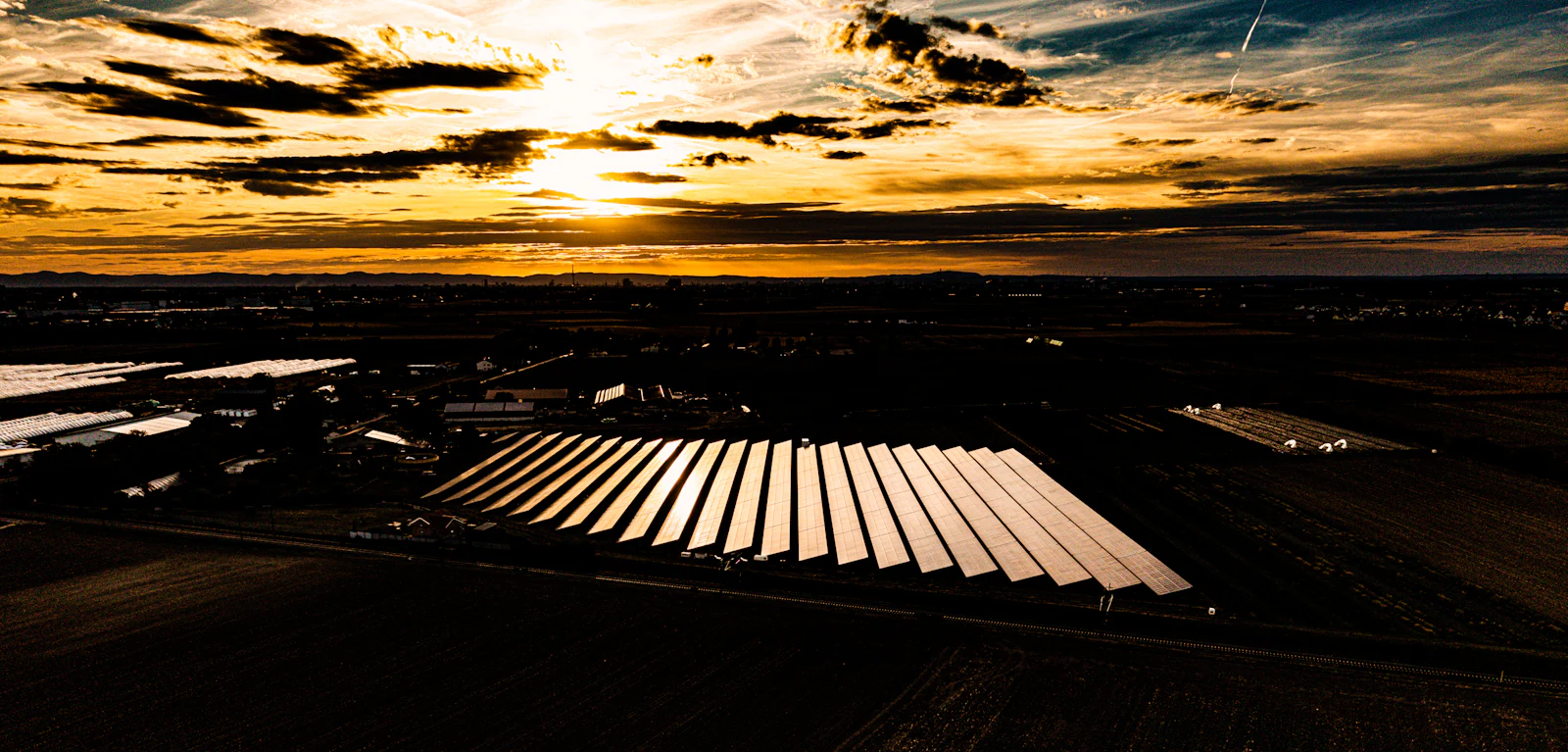 Aerial view of a large solar plant at sunset