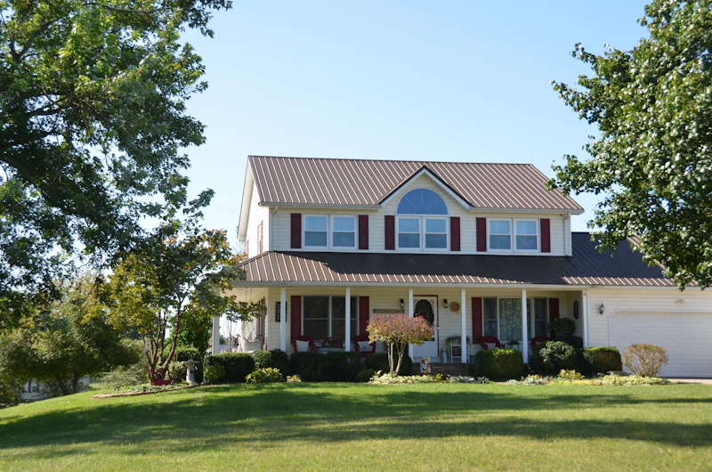 Two-storey home with cream siding and a metal roof in Armstrong