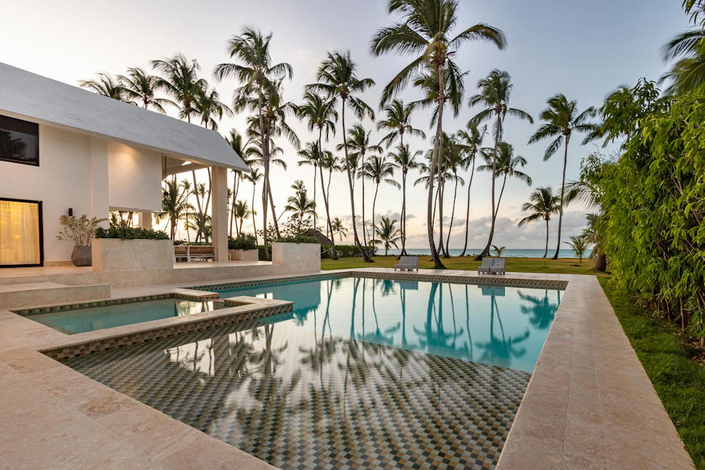 Beachfront villa with infinity pool and palm trees