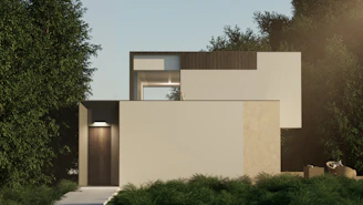 A modern minimalist house with clean lines surrounded by lush green trees