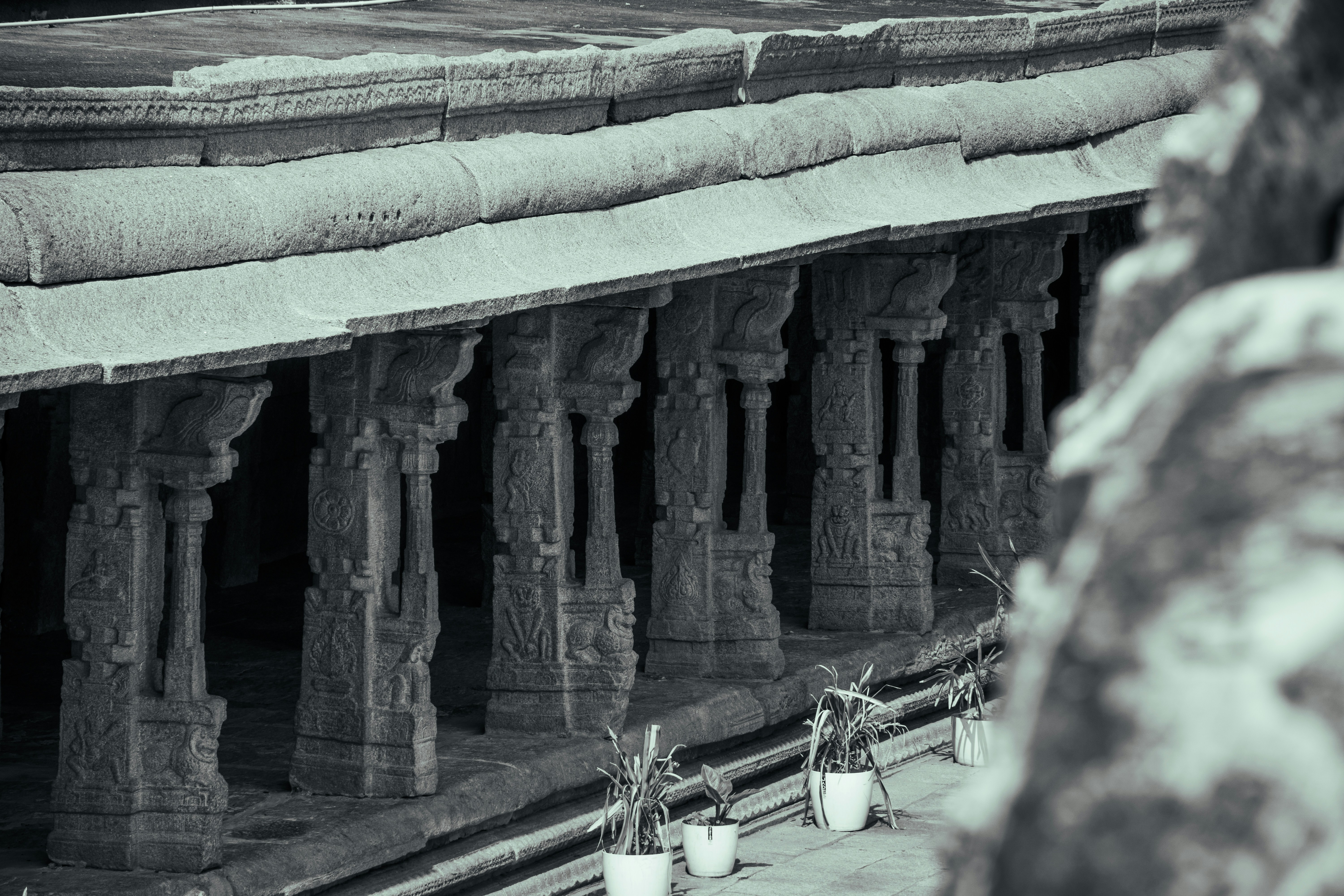 Carved stone pillars supporting a roof in a historic temple courtyard