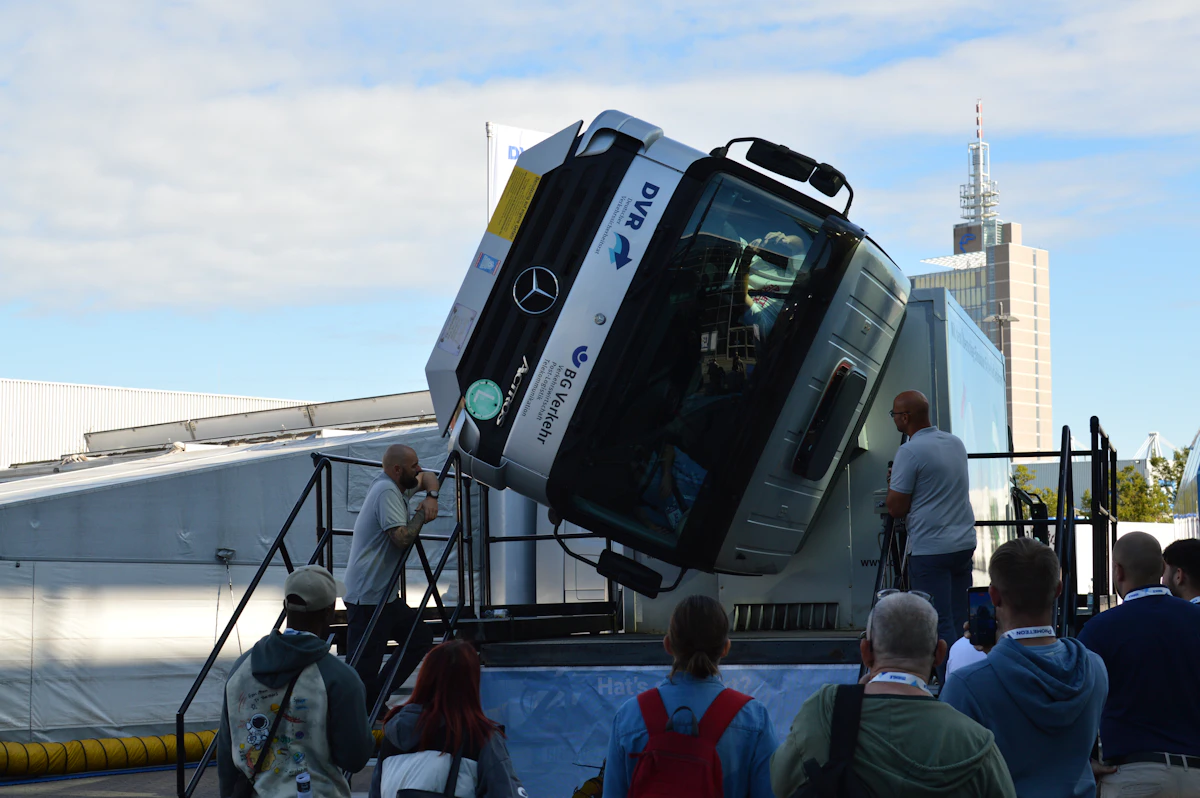 Crowd watching a vehicle reveal on a platform at a product launch