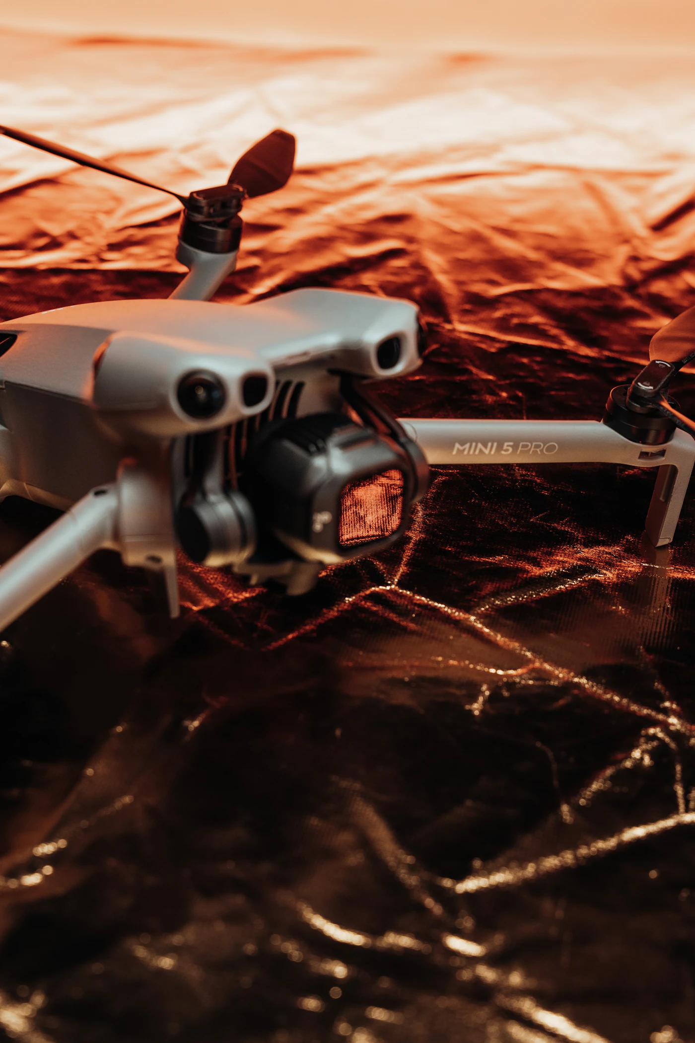 A DJI Mini 5 Pro close up, its name printed on the arm