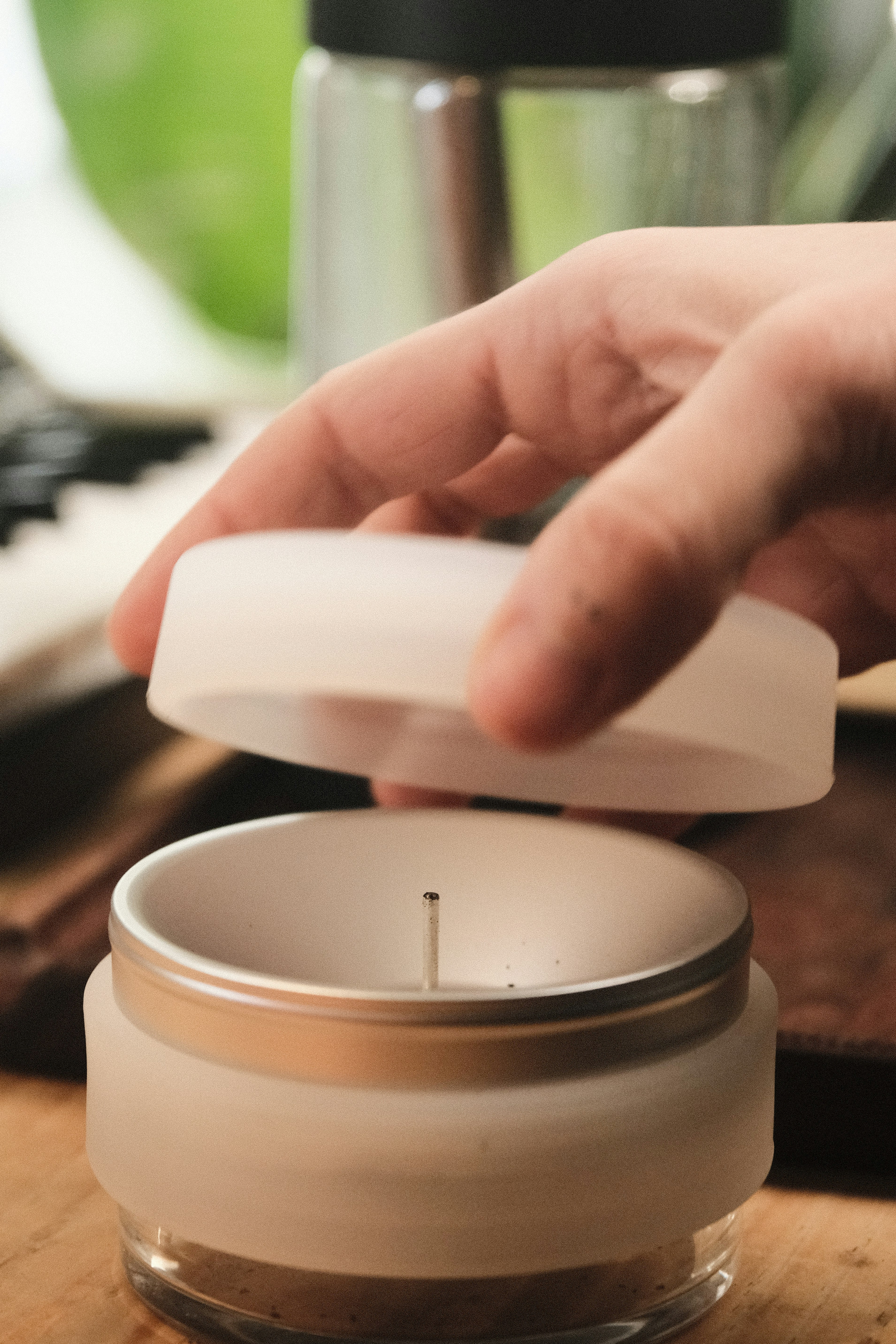 Hand lifting lid from candle jar - Free Photo on Unsplash