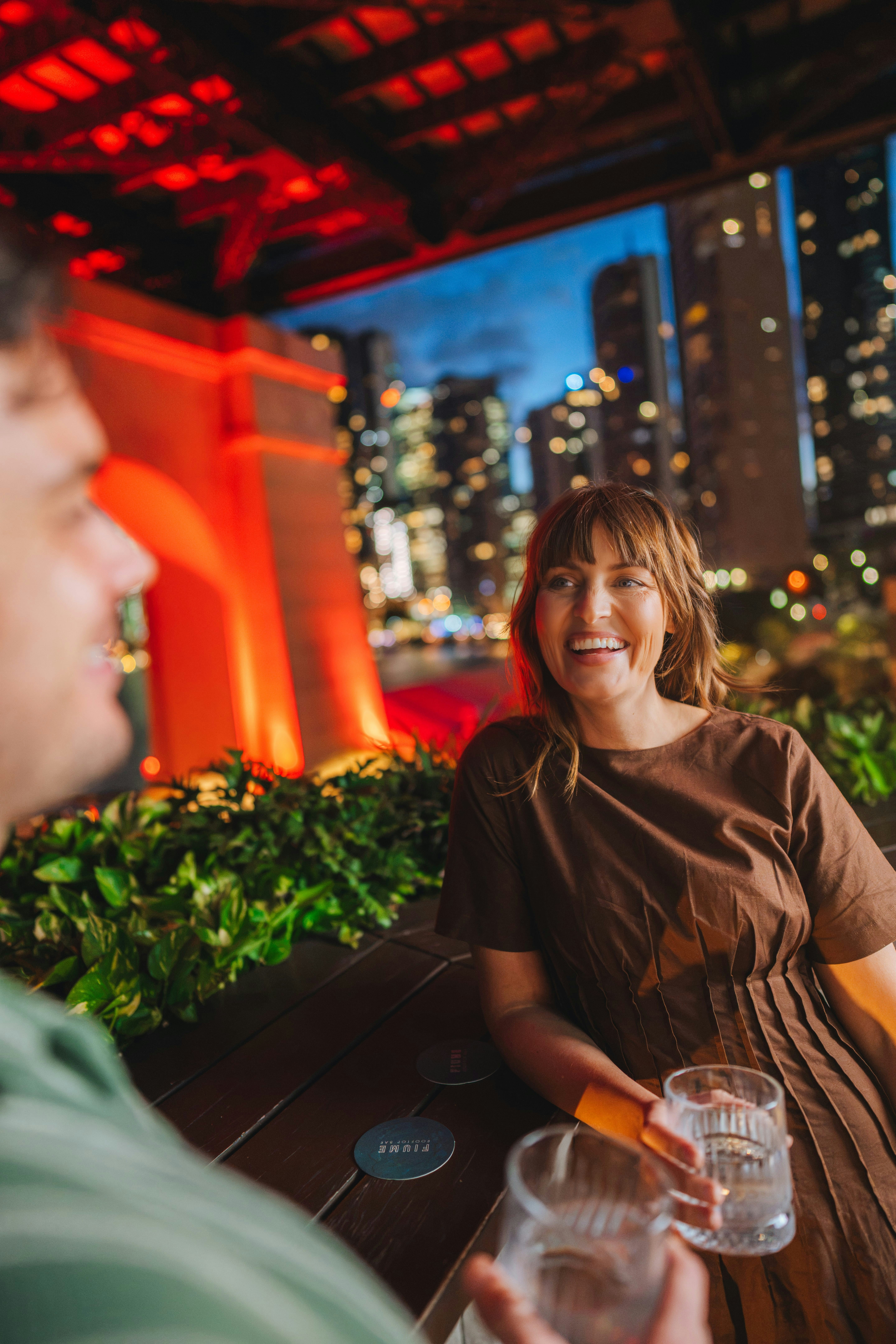 Couple enjoying a drink at Fiume Rooftop Bar at Crystalbrook Vincent, with the Story Bridge and Brisbane City in the background - 相关推荐