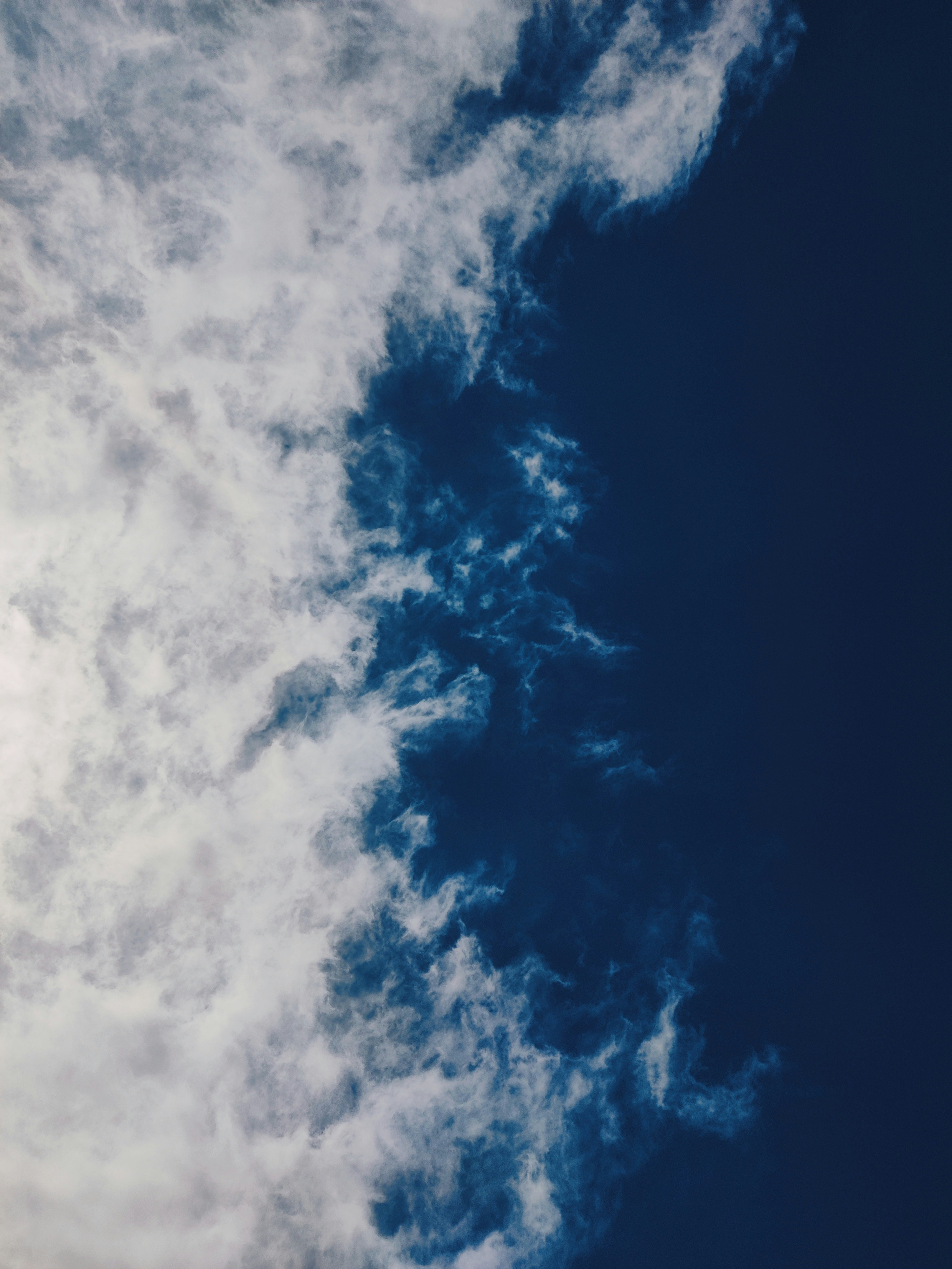 Wispy white clouds against a deep blue sky