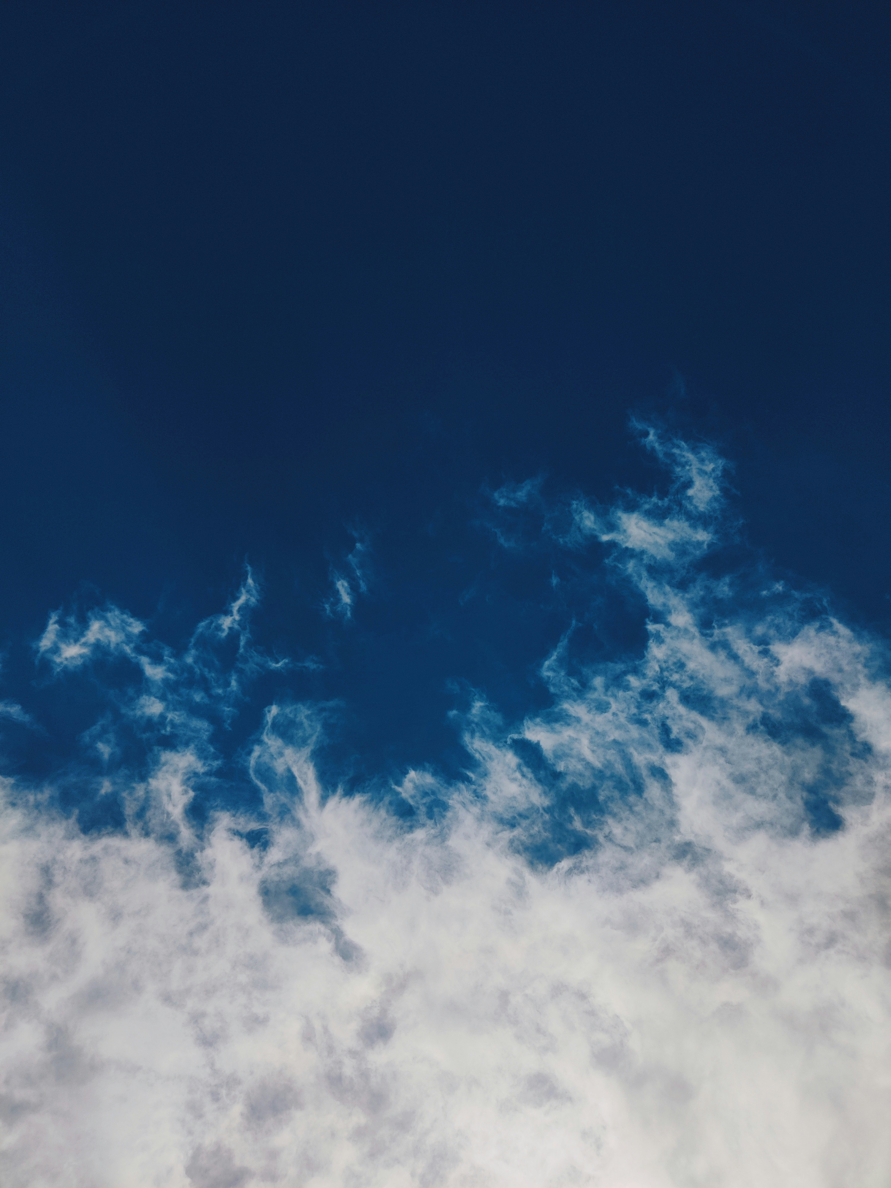 Wispy white clouds against a deep blue sky