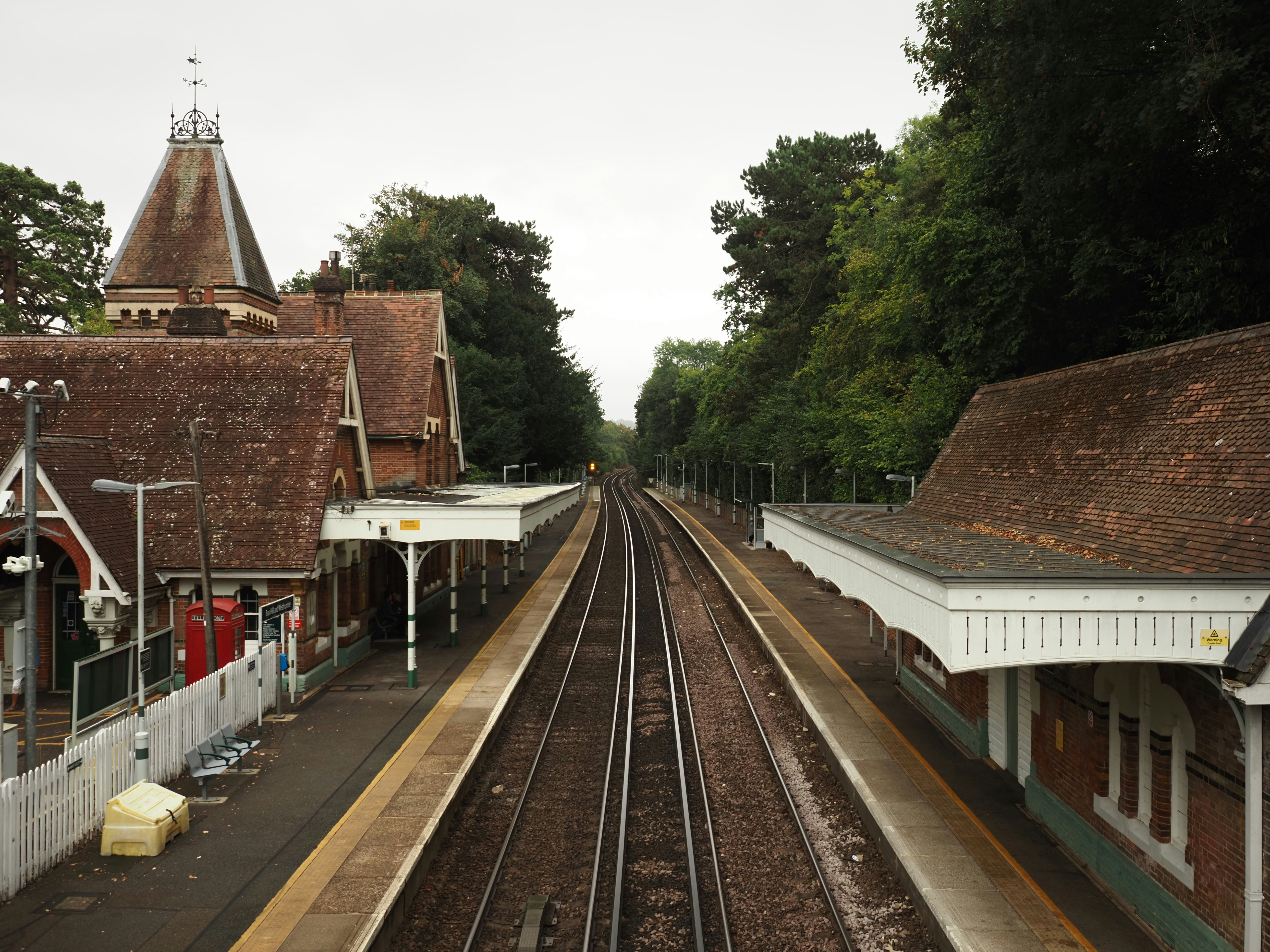 Historic brick railway station beside the tracks