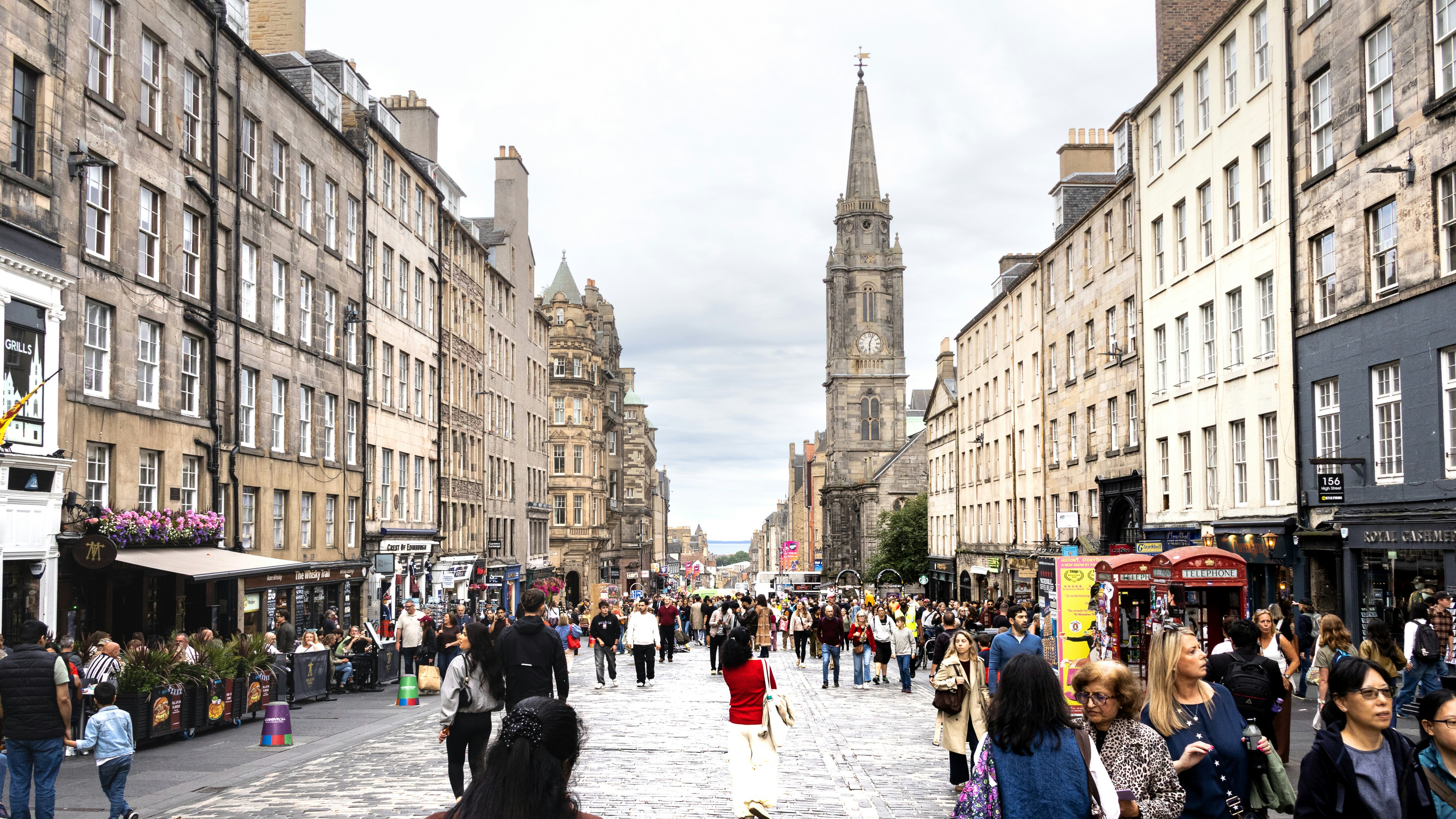 Crowds of people walking along the historic Royal Mile in Edinburgh, Scotland