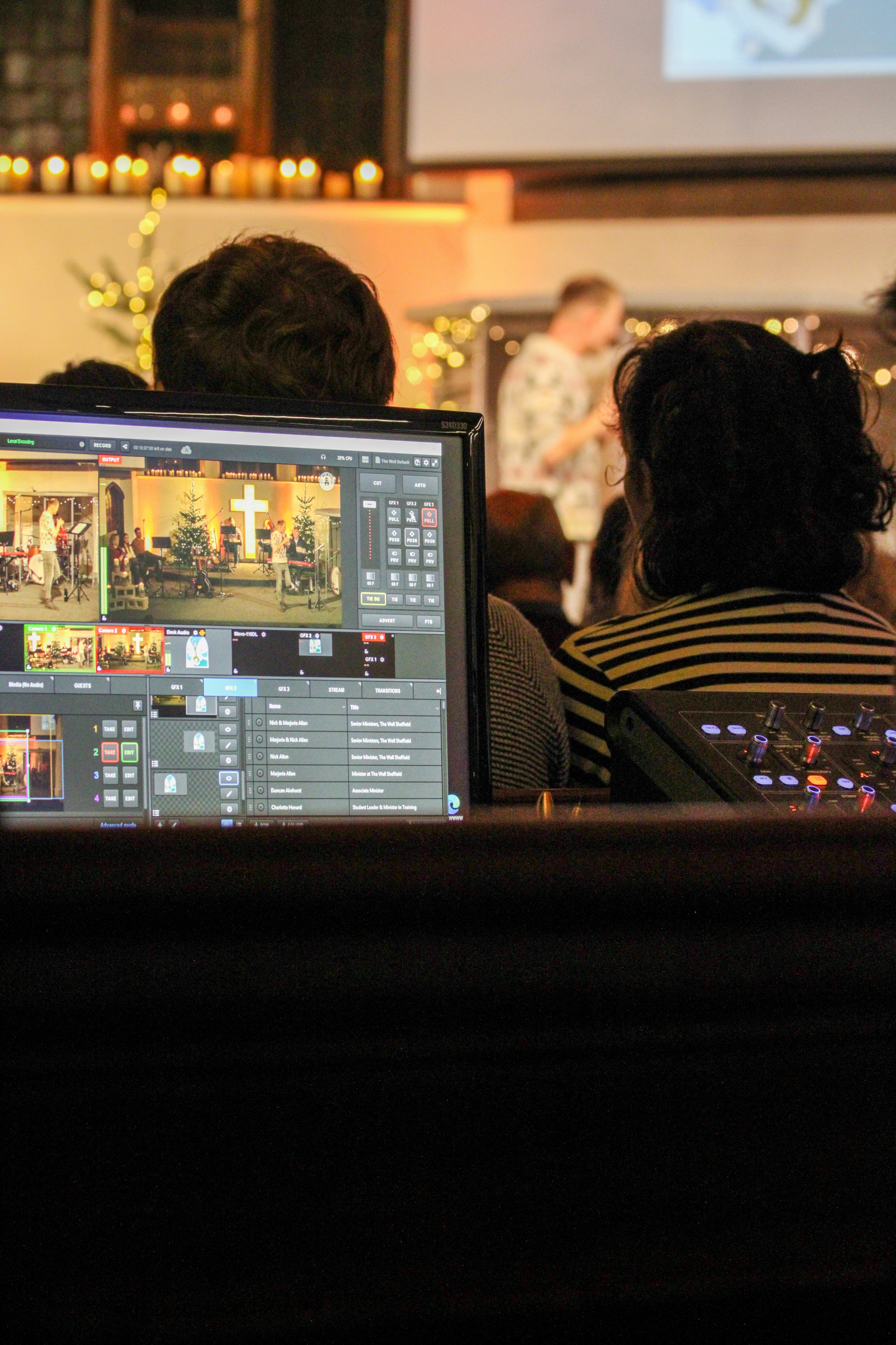 A person monitoring a live video feed of a church service on a computer