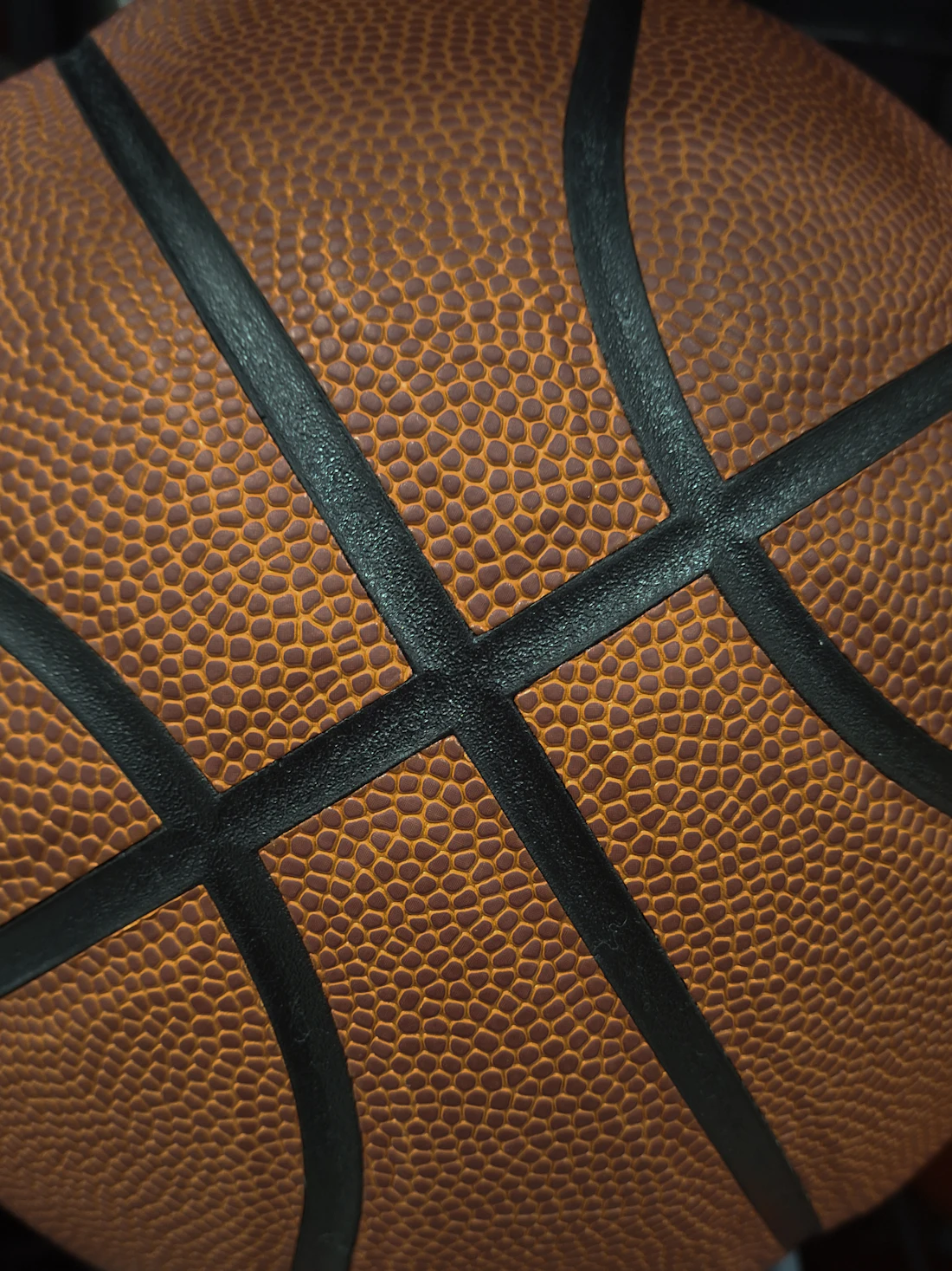 Close-up of the textured surface and seams of a basketball