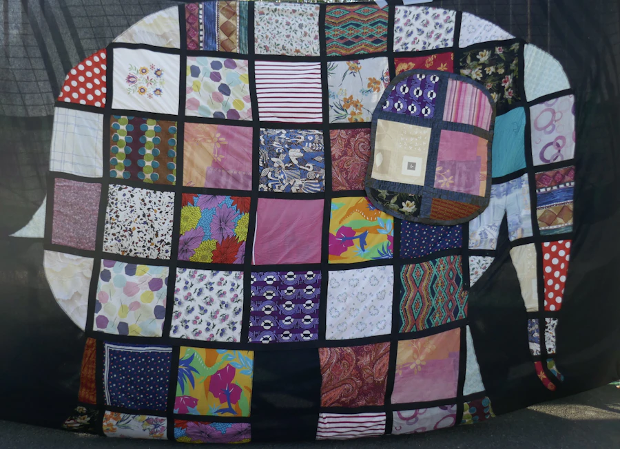 Appliqué elephant made of colorful fabric pieces with stitched borders