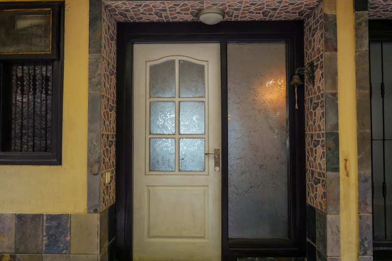 White door with glass panels beside a frosted sidelight