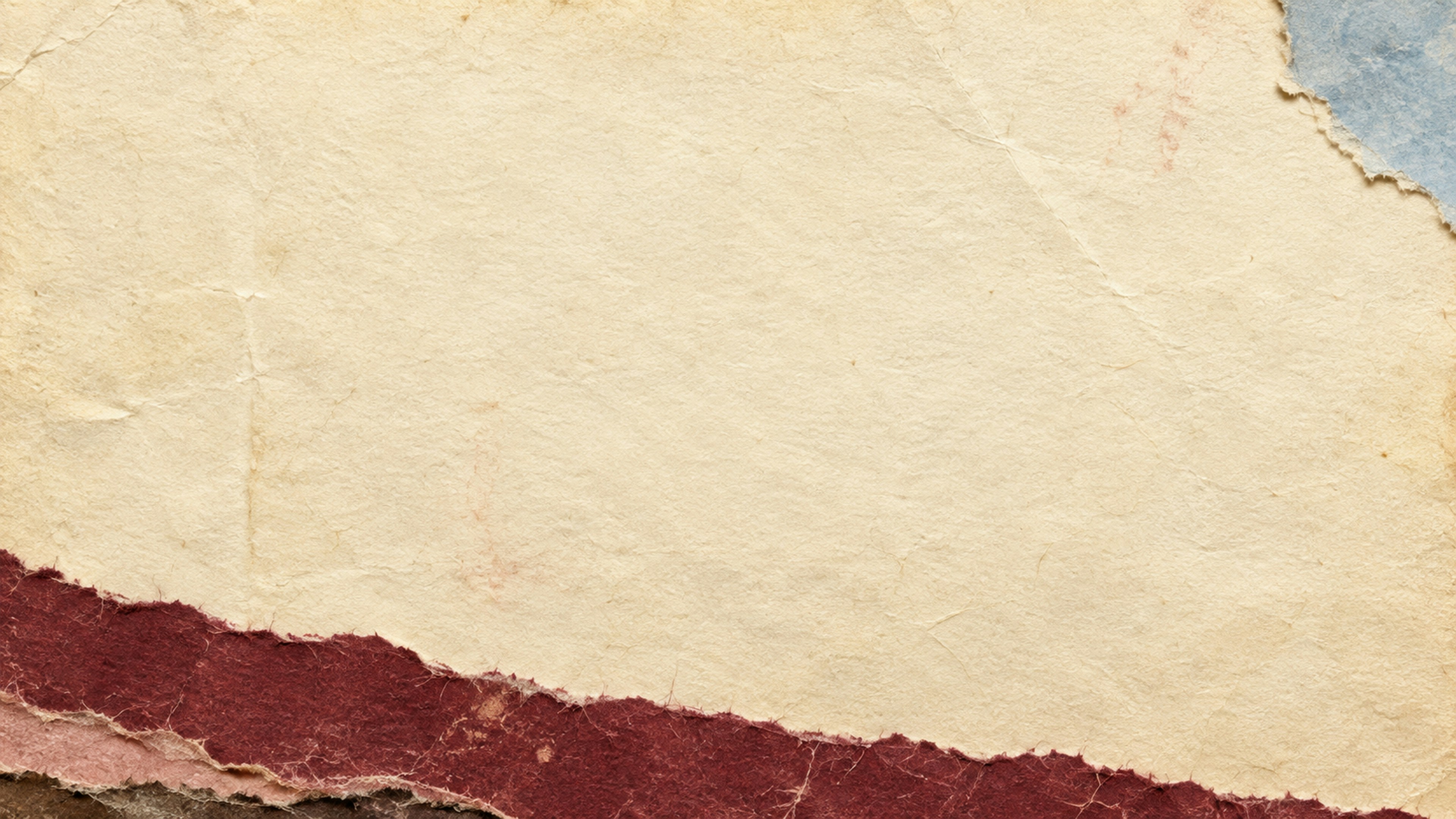 Layers of torn beige, dark red, and blue paper with textured edges