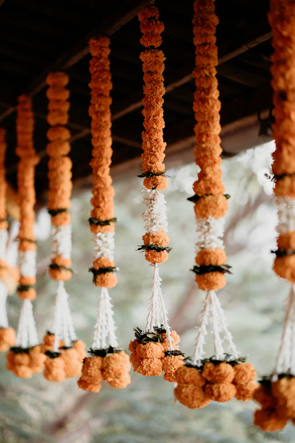Strings of marigolds and jasmine hanging in a row