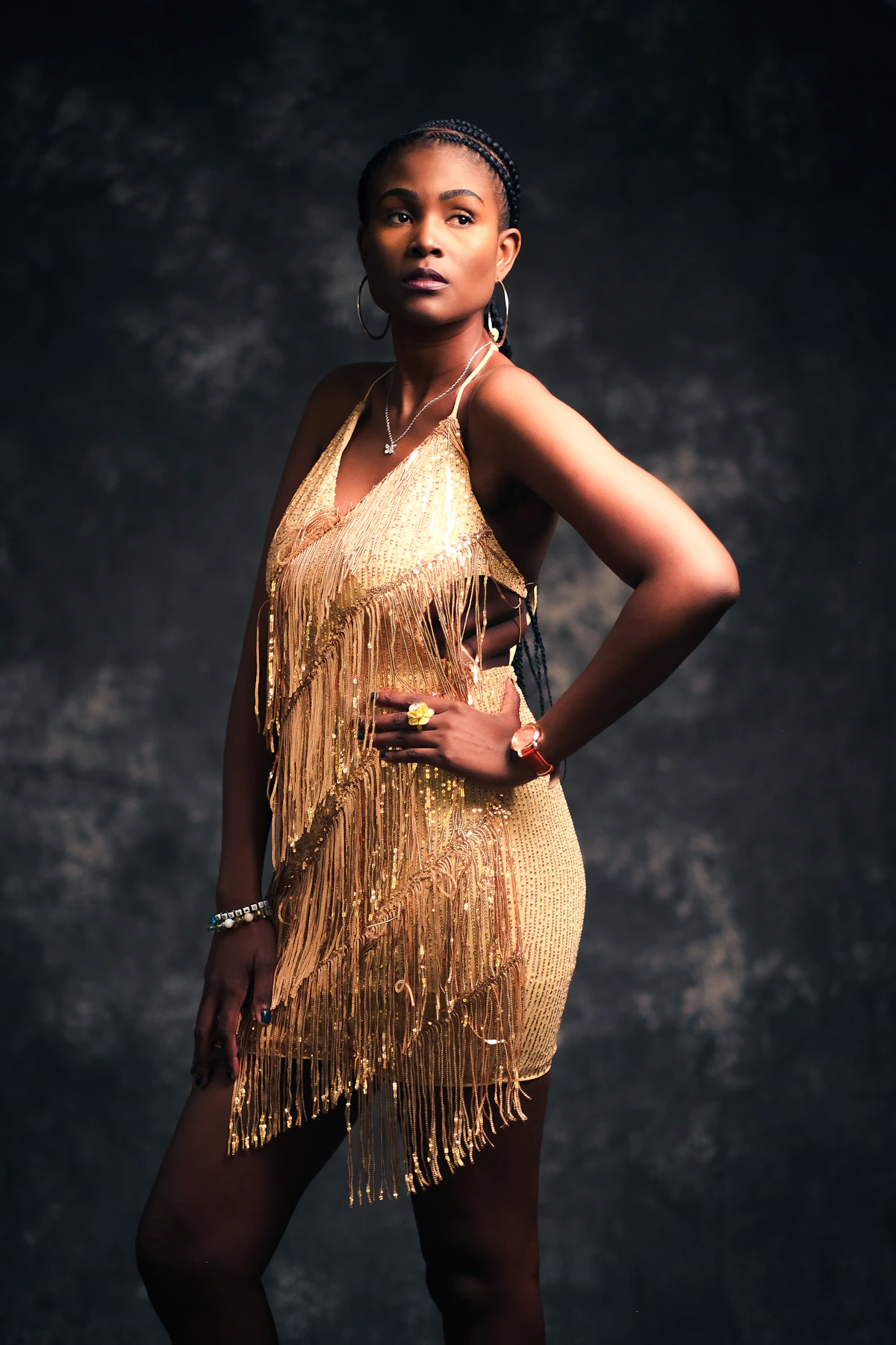 Woman in a gold fringed cocktail dress