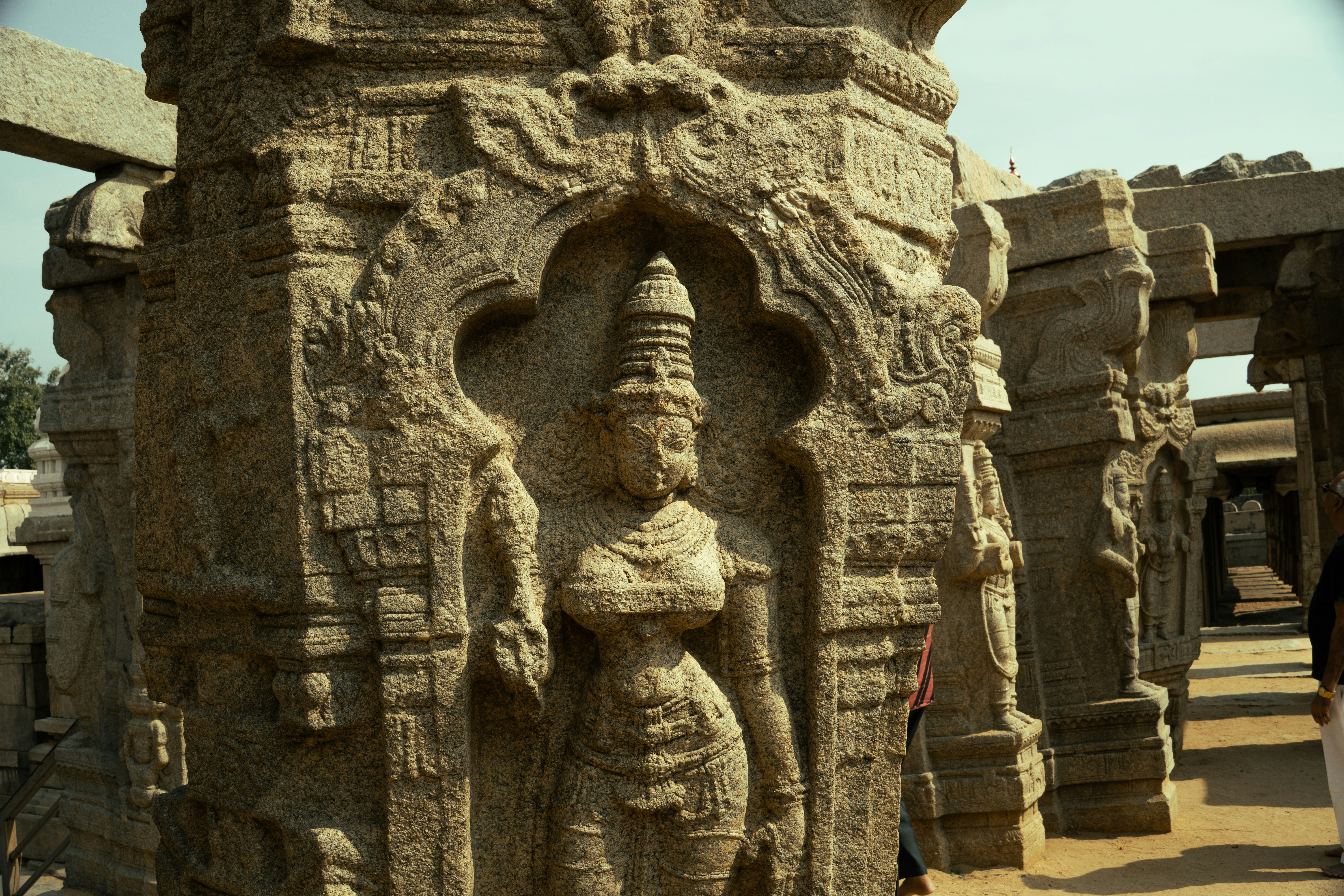 Carved stone figure of a deity on a pillar at Hampi in India