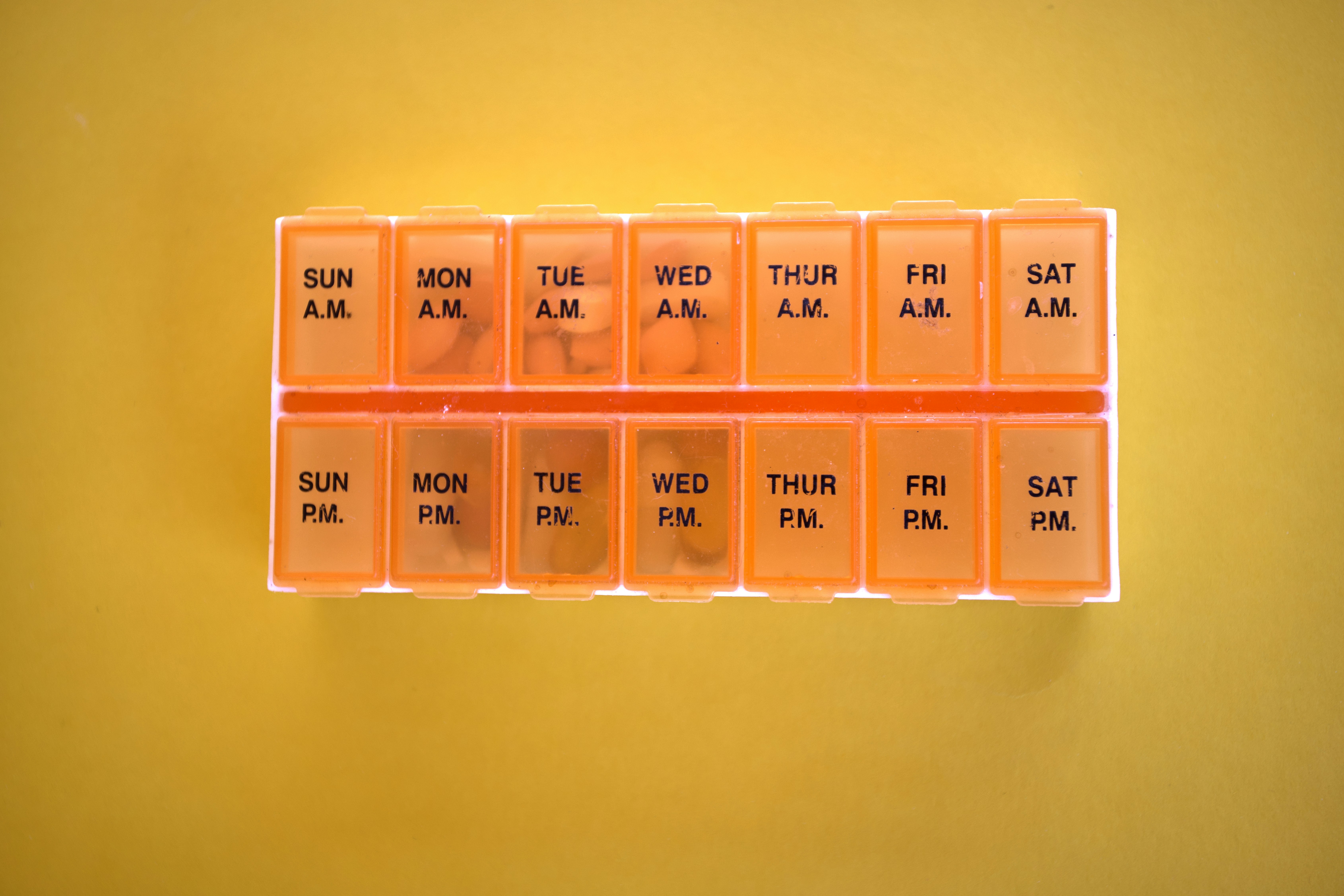 A weekly pill organizer with daily compartments