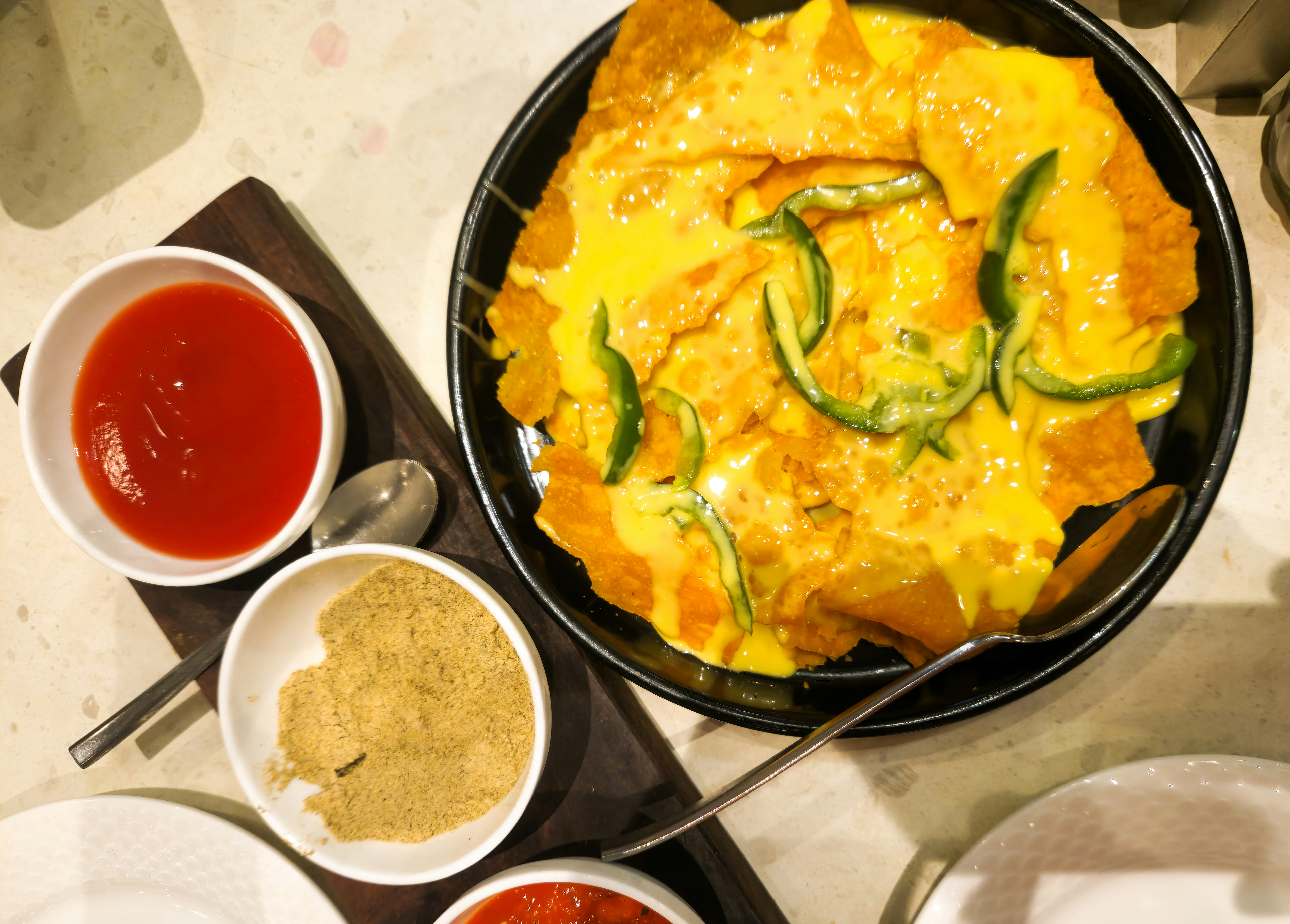 Nachos with melted cheese and green peppers