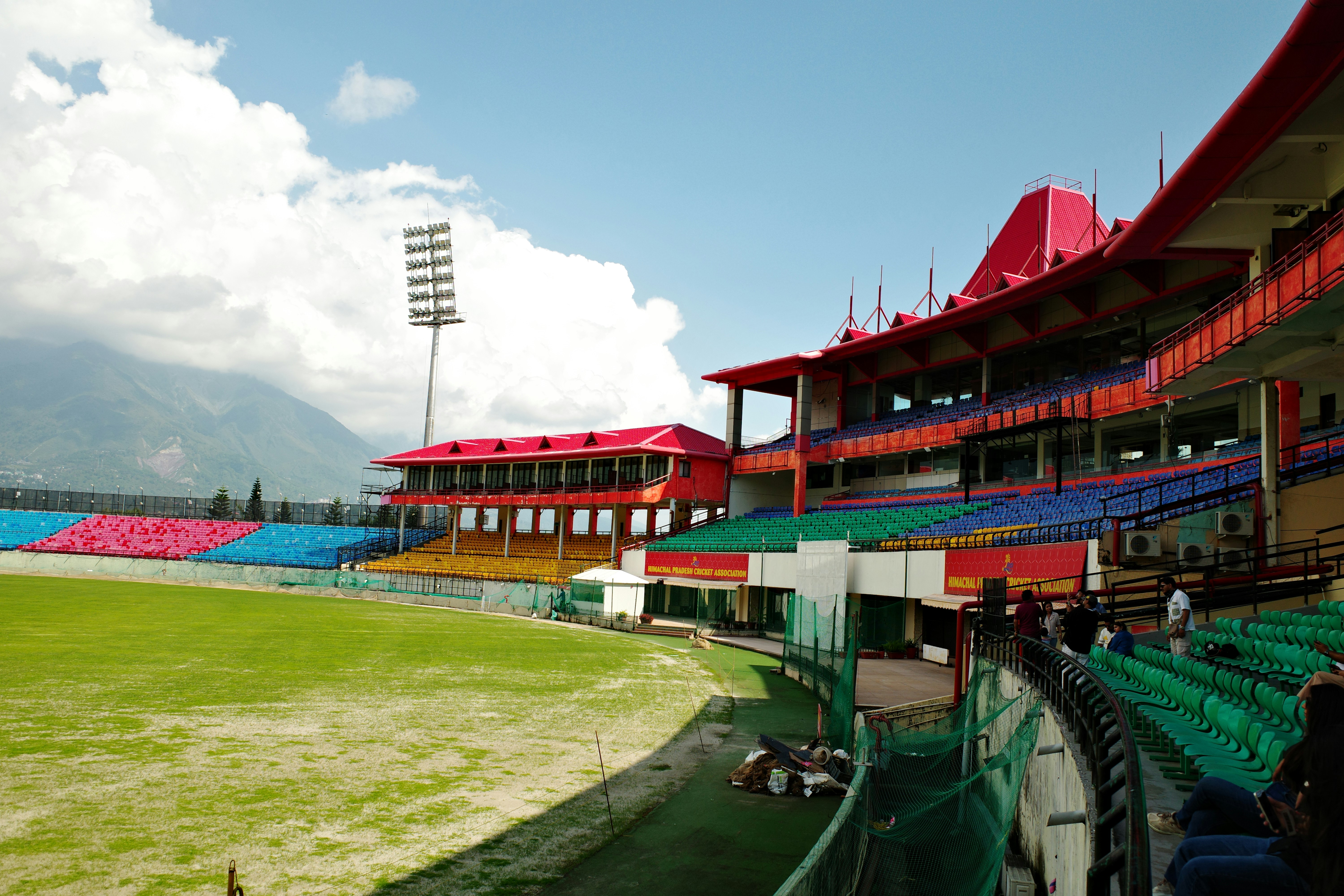 The Himachal Pradesh Cricket Association Stadium with colorful seating and mountain views