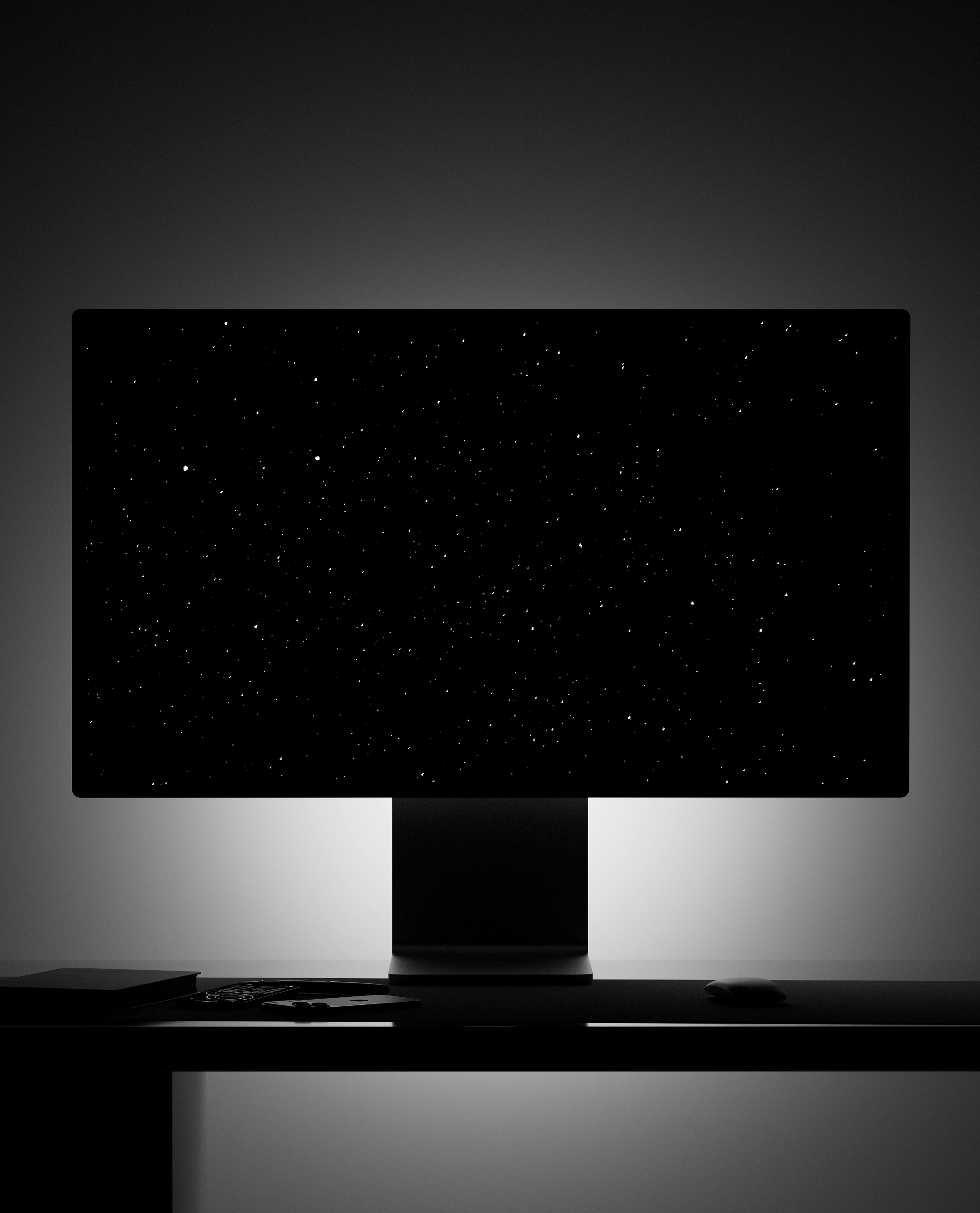 A computer monitor displaying a starry night sky on a dark desk