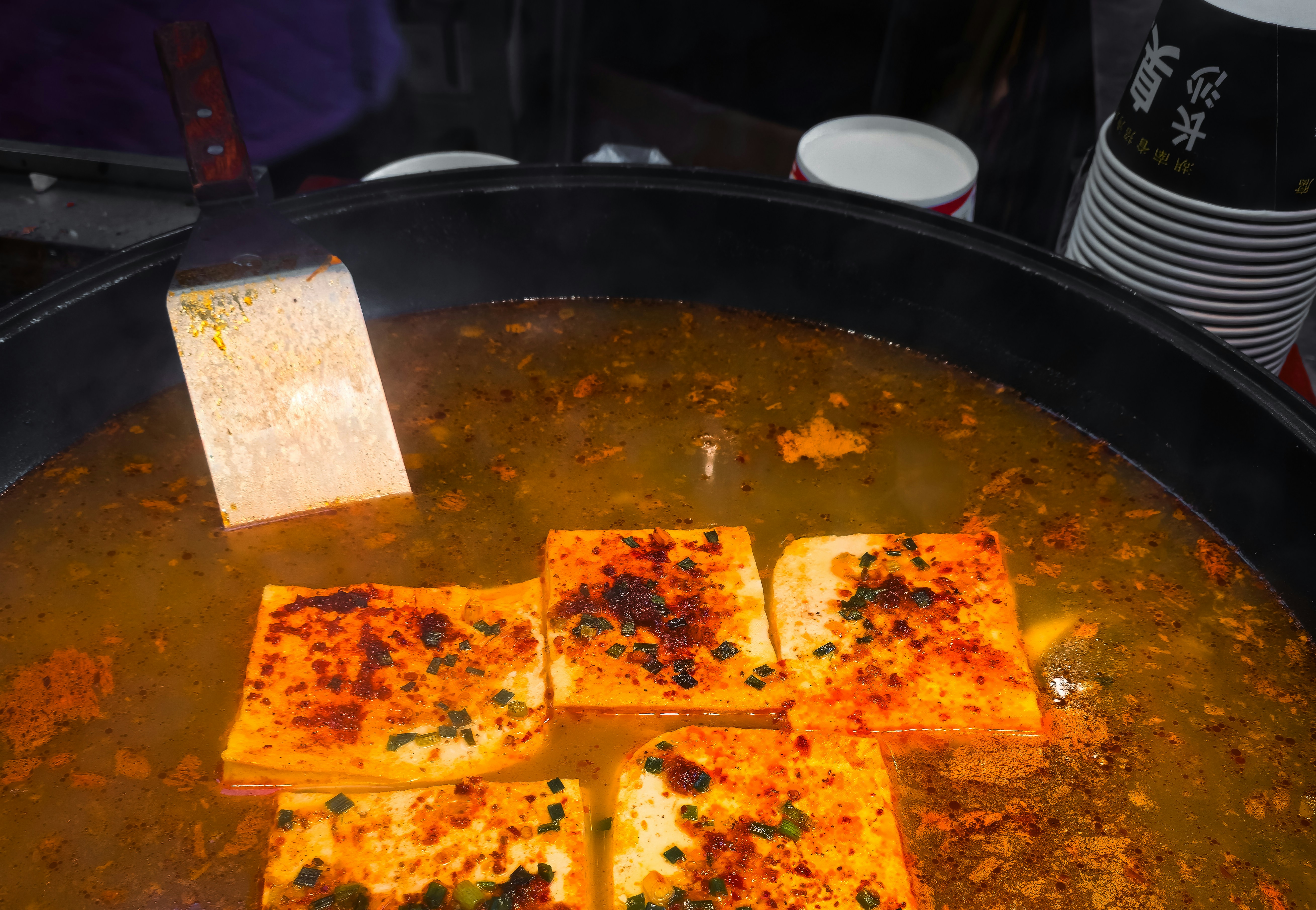 Tofu simmering in spicy red broth