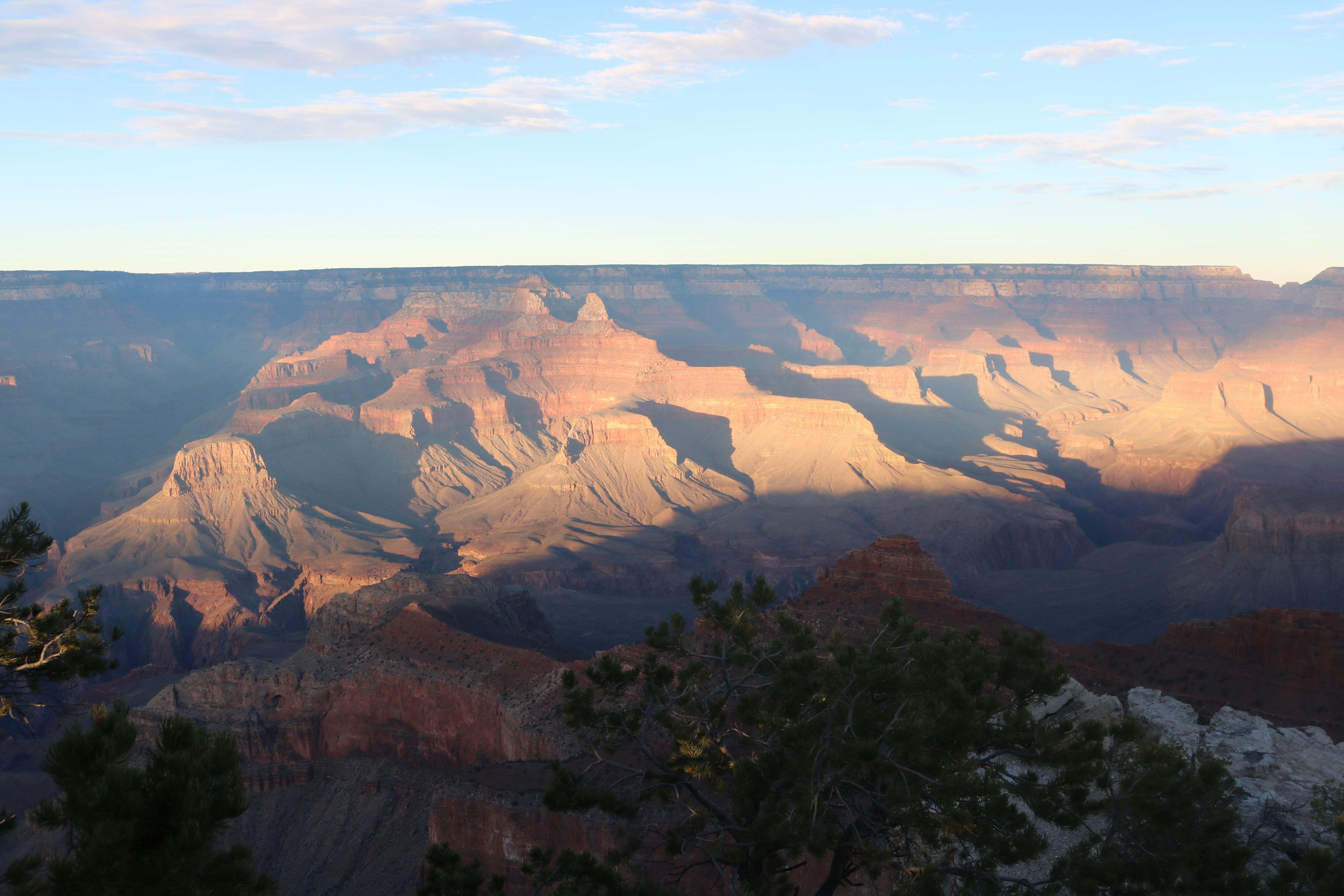 The Grand Canyon with layered rock formations under a clear blue sky