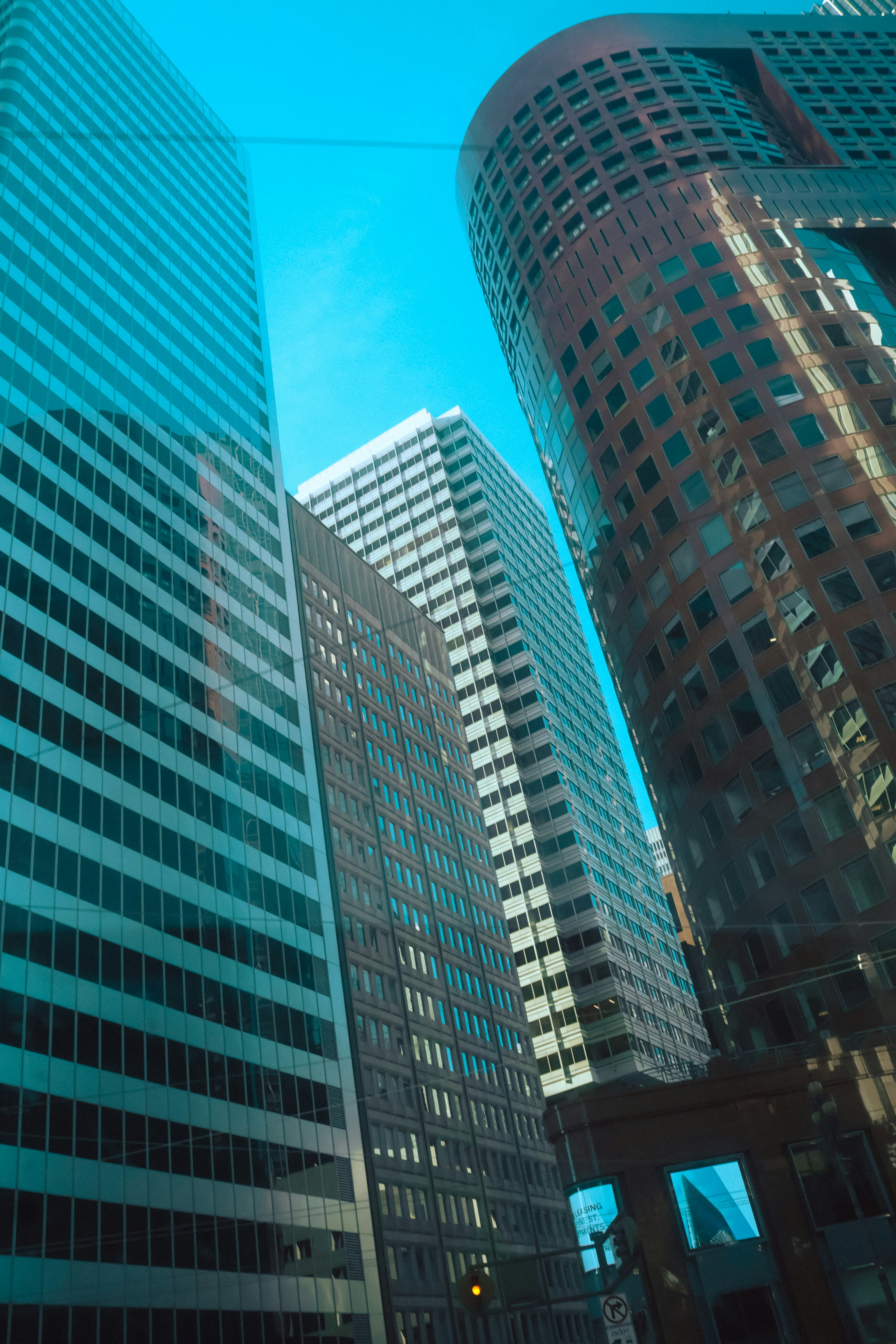 Modern glass skyscrapers rising into a clear blue sky in a city center