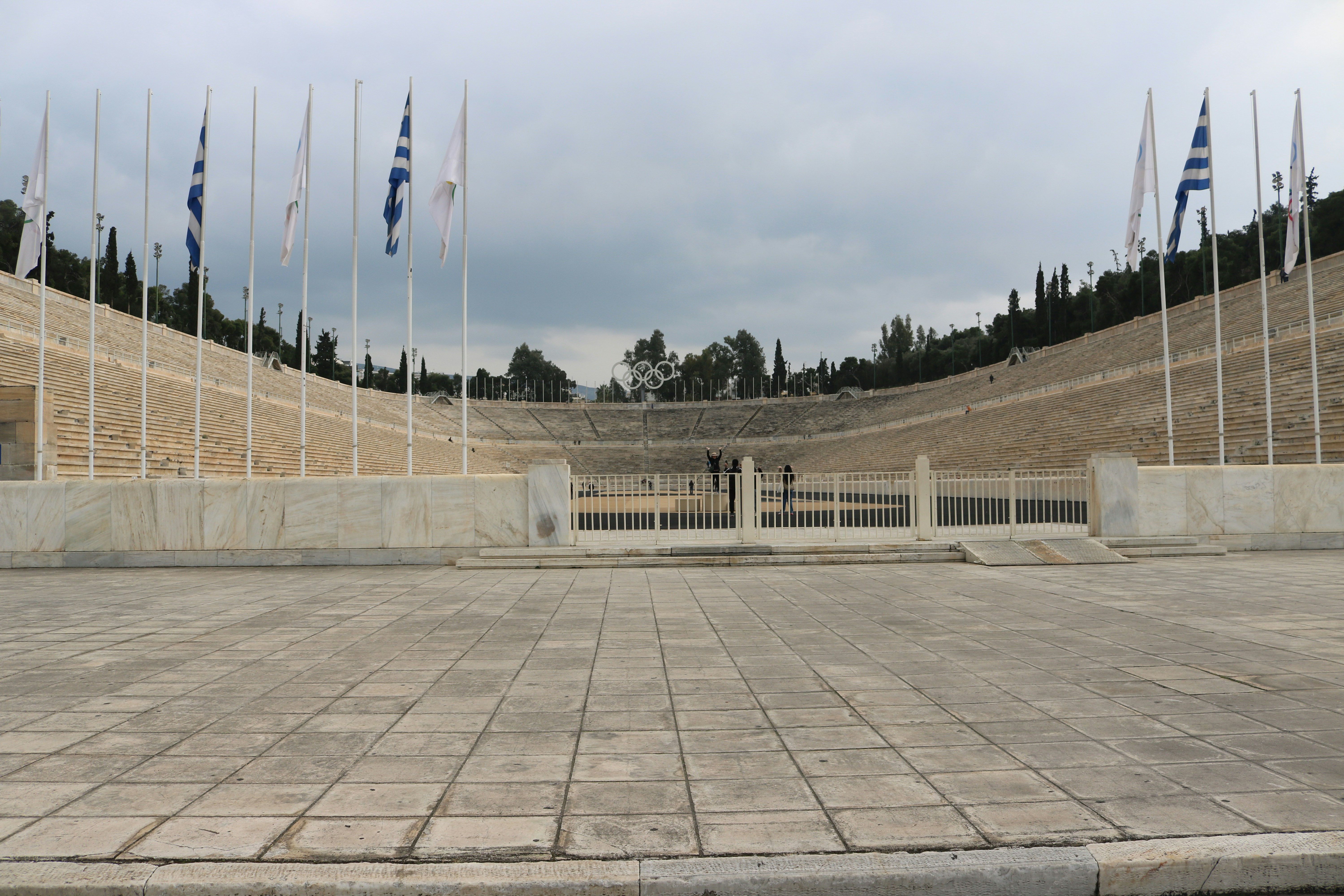 The Panathenaic Stadium with marble seating and flags in Athens, Greece