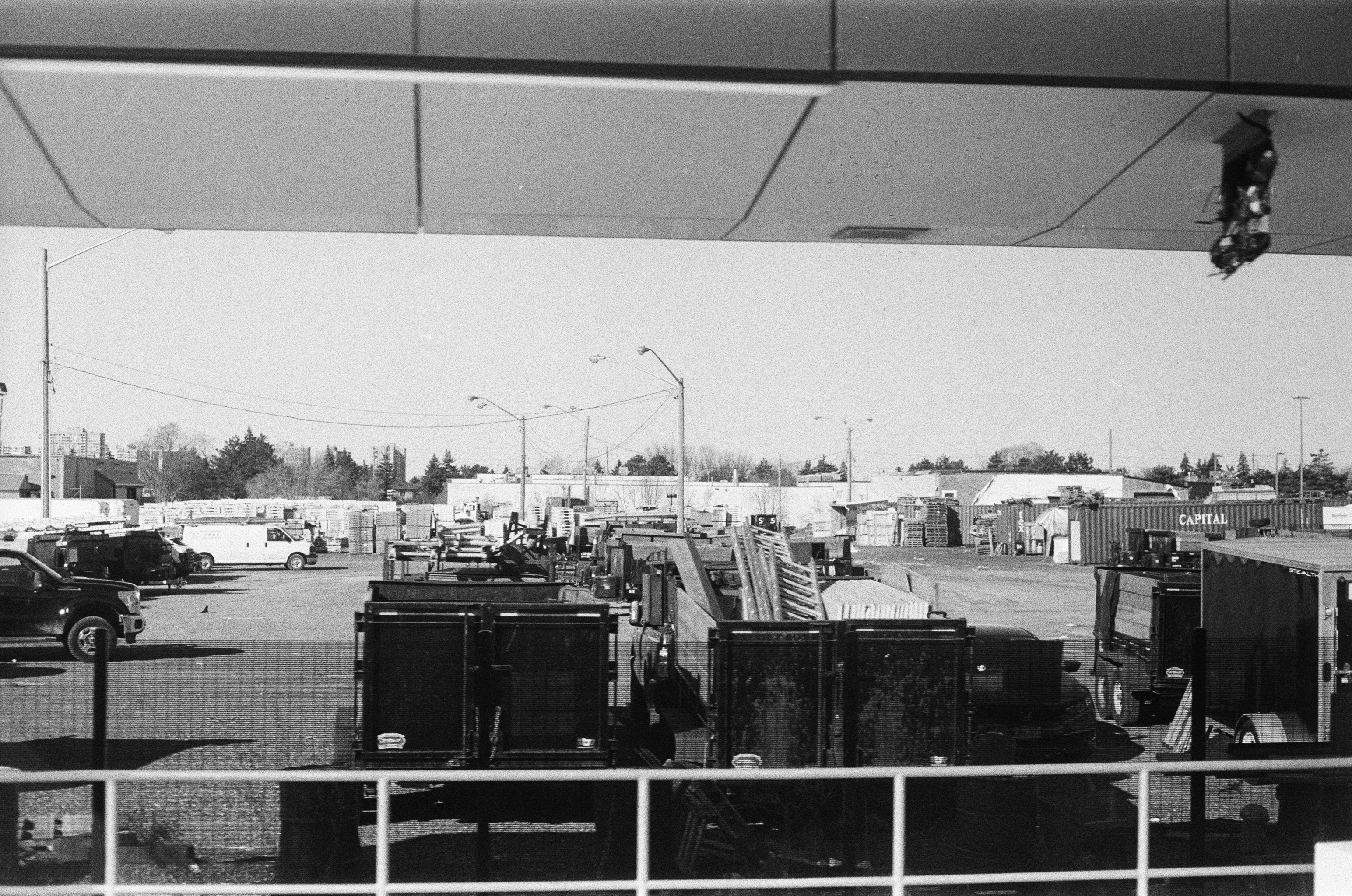 Gravel yard with work trucks, trailers and equipment