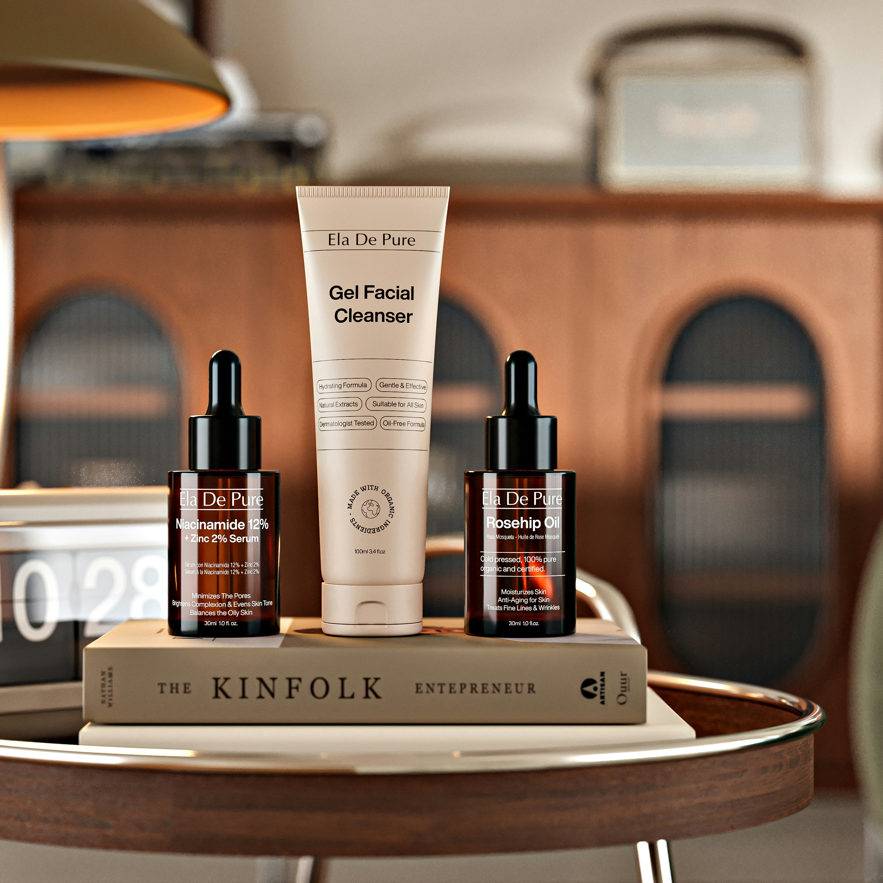 A facial cleanser tube and two serum bottles on a book on a table