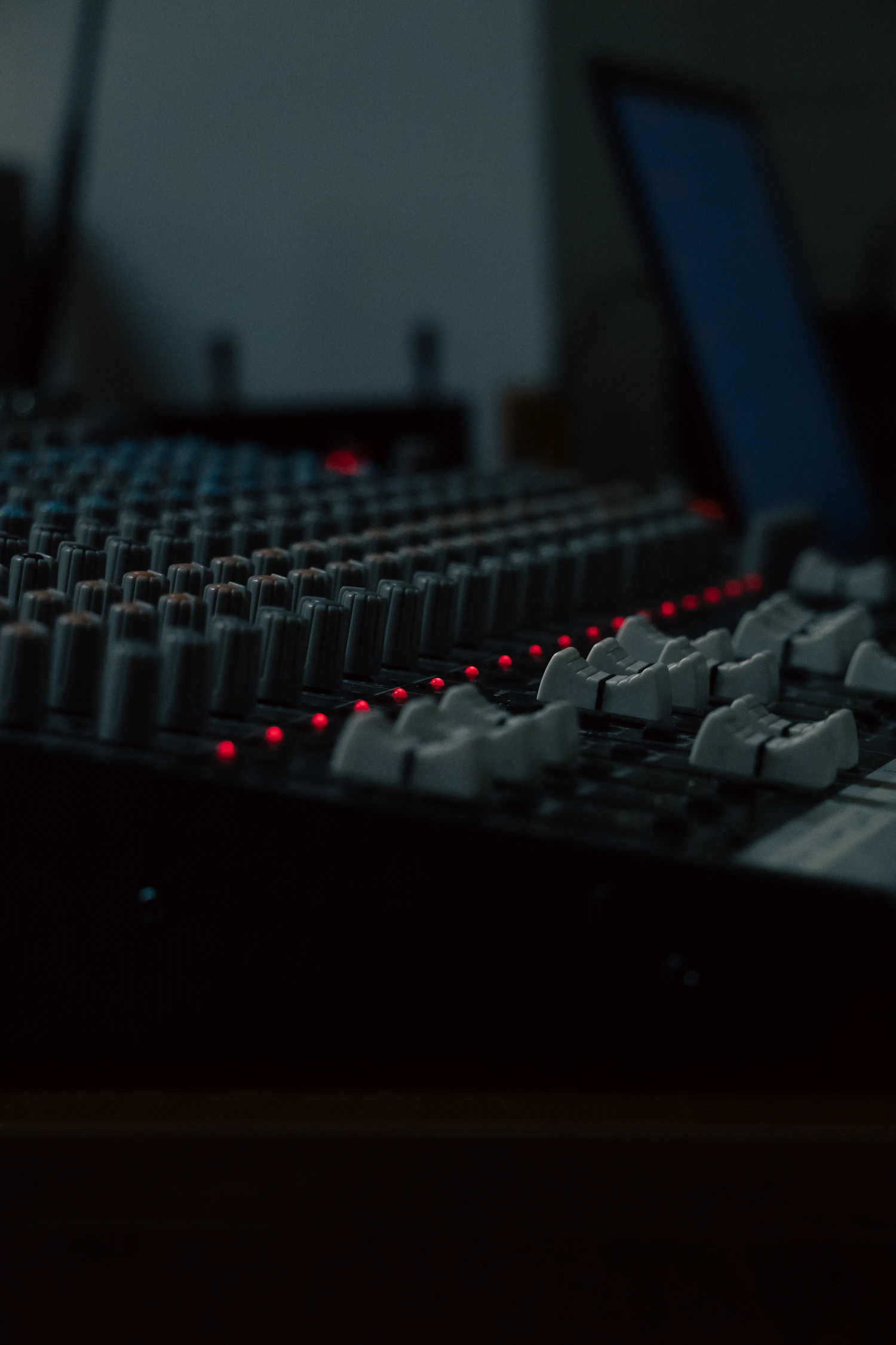 The Coldboot test rack at night, a long desk of faders and red indicator lamps running a soak on four units