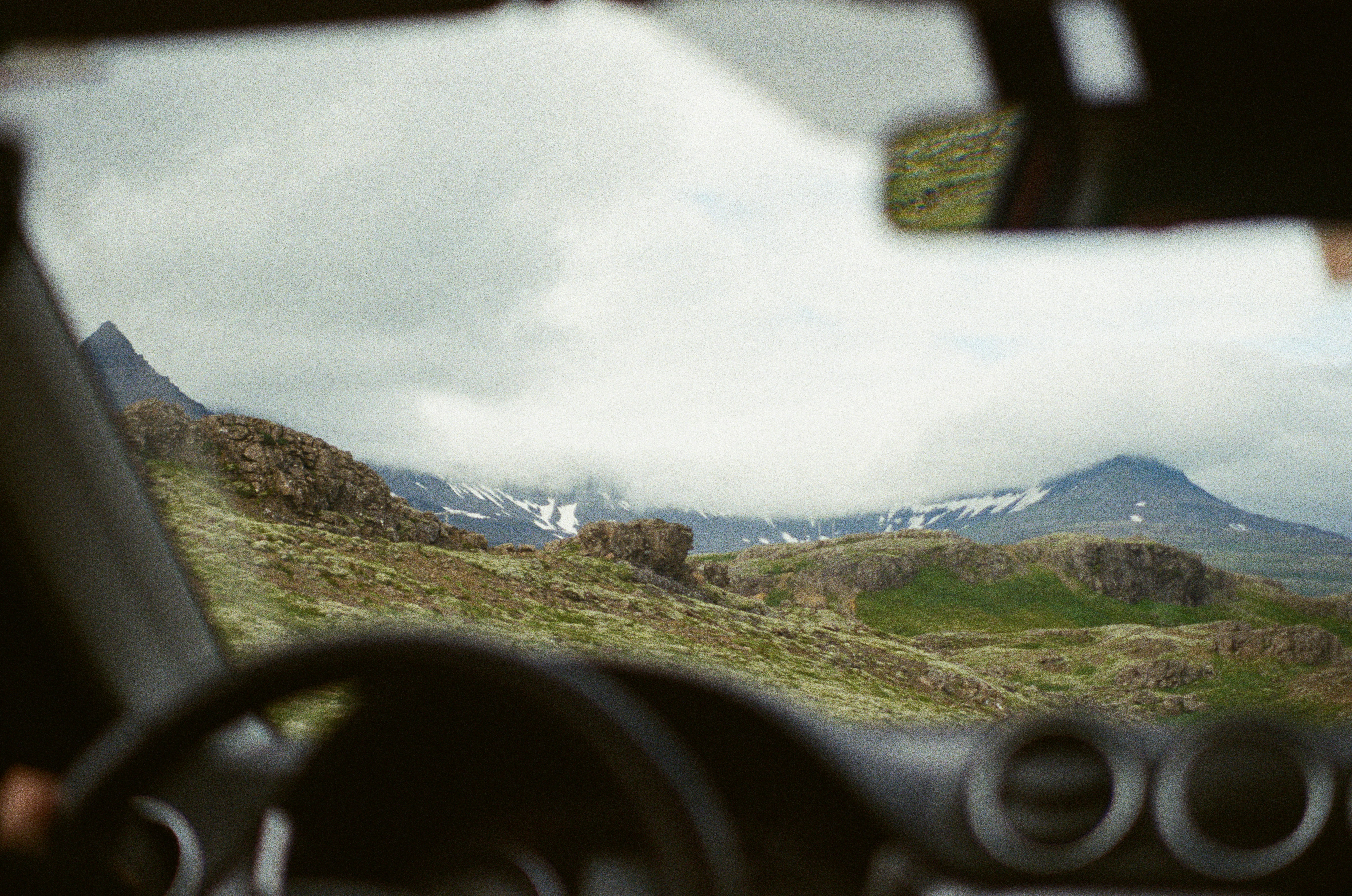 View of Snow-capped Mountains from Inside a Car with a