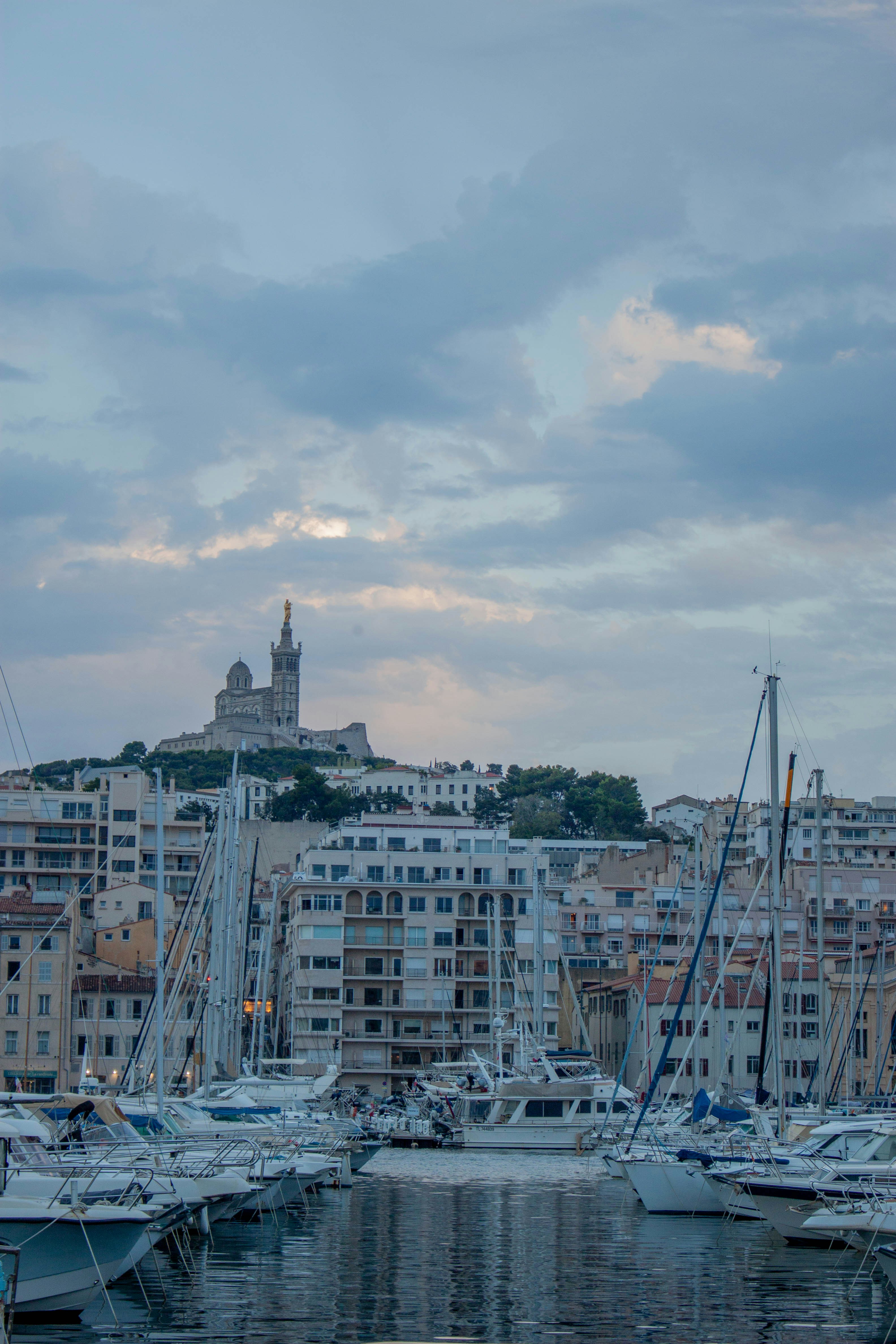 Sailboats moored in the Vieux-Port with Notre-Dame de la Garde in Marseille