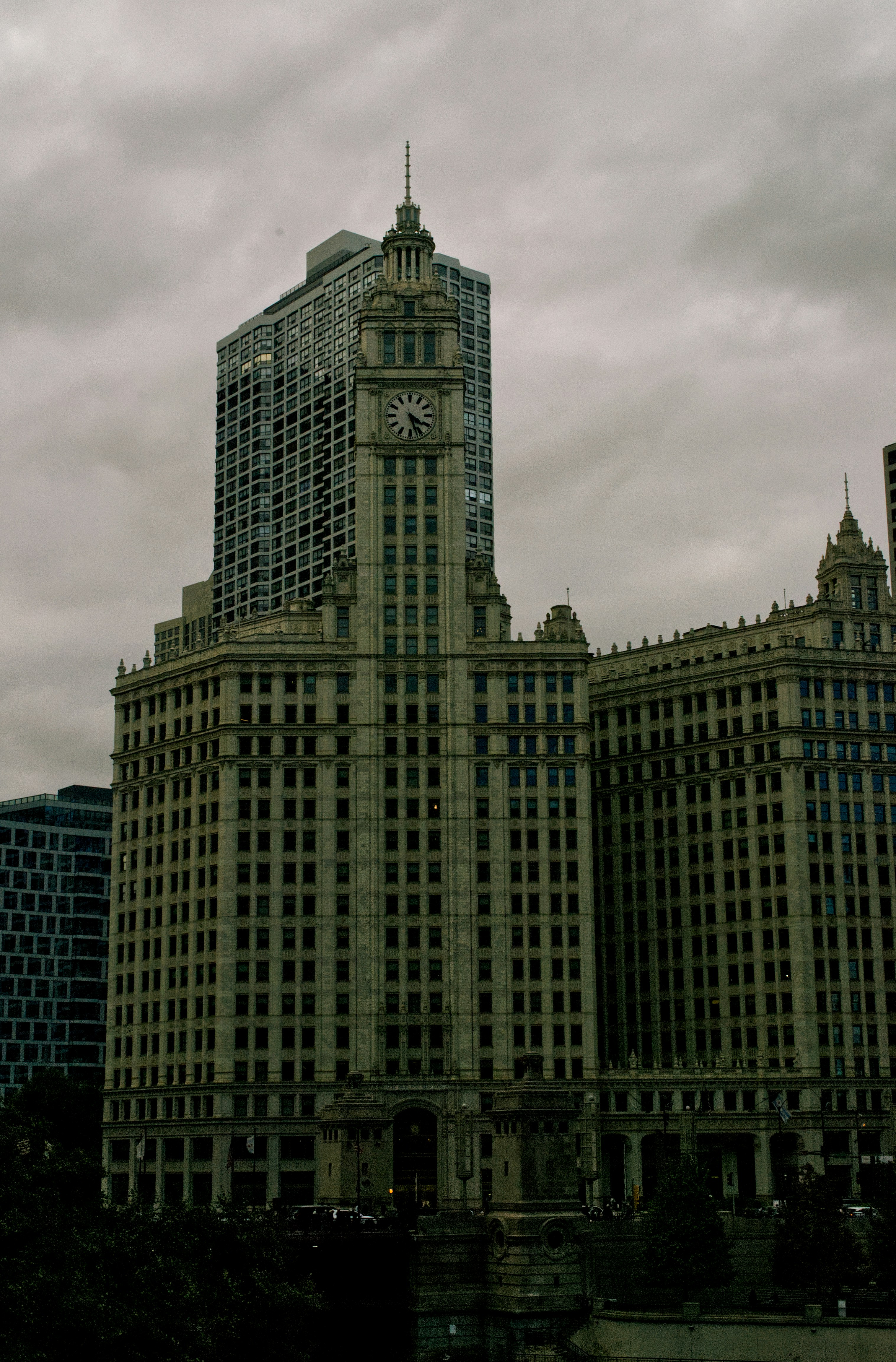 The Wrigley Building with its clock tower under a cloudy sky in Chicago