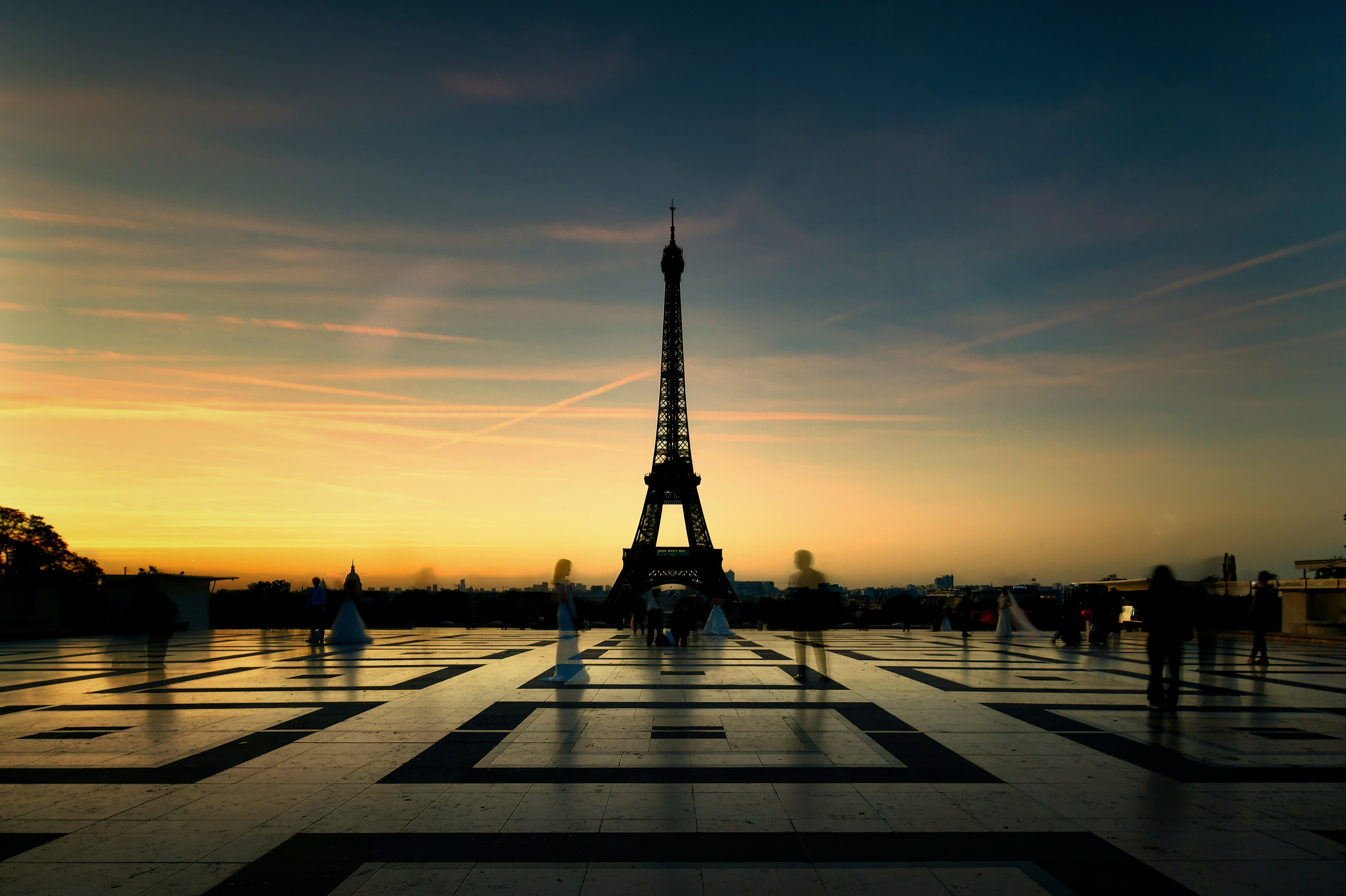 Silhouettes of people on the Trocadéro plaza before the Eiffel Tower in Paris