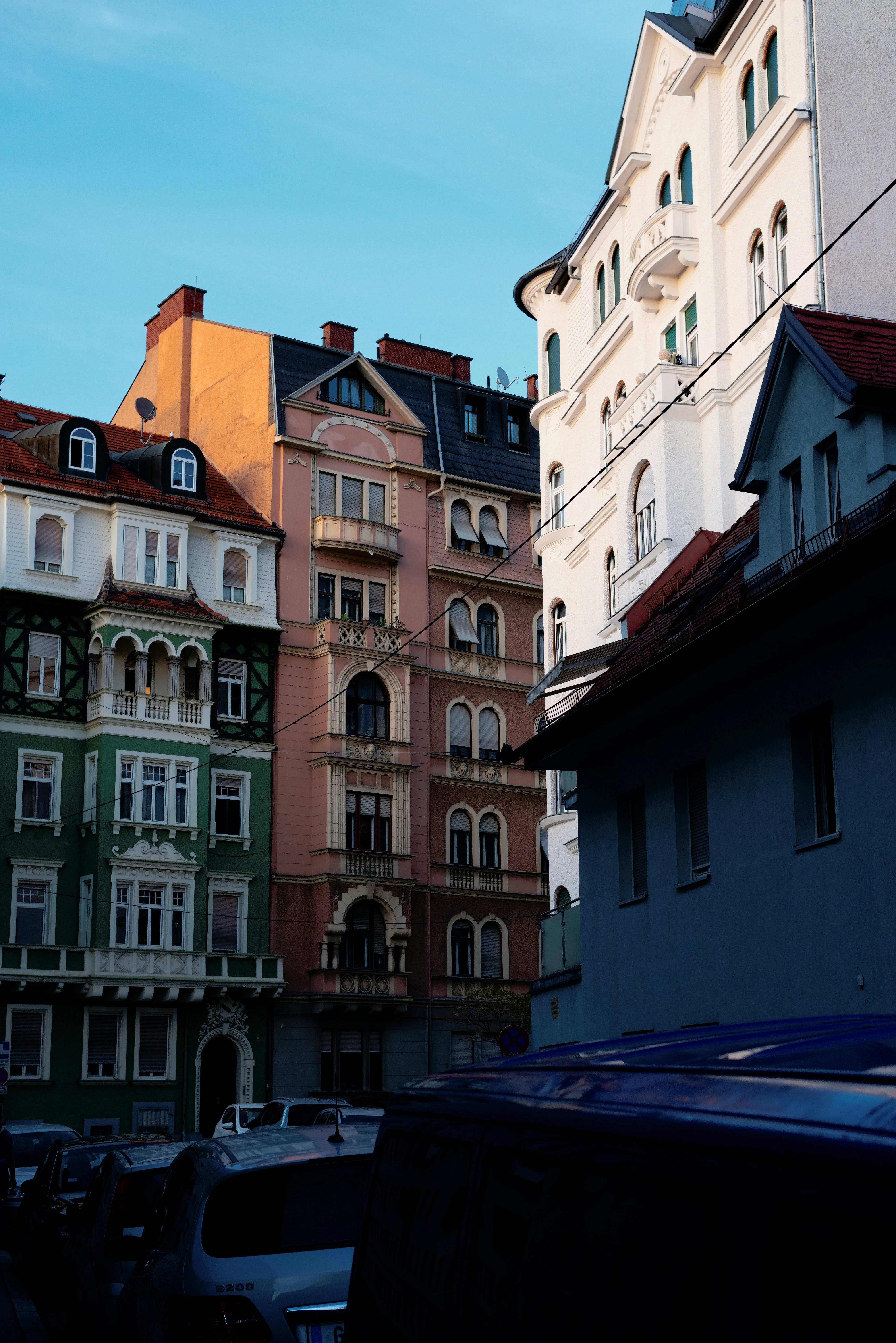 Colorful historic apartment buildings with ornate facades on a city street