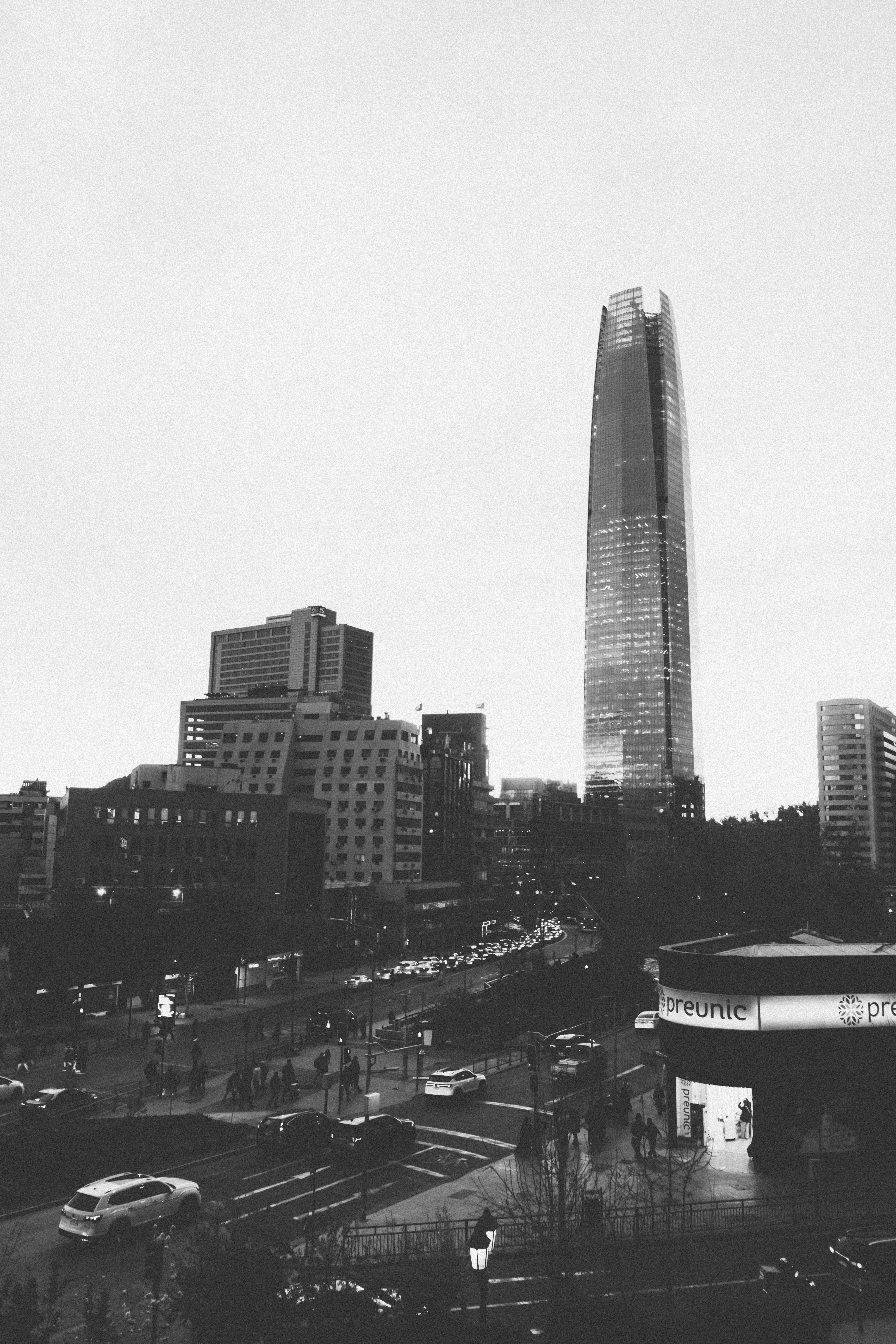 The Gran Torre Santiago skyscraper rising above a busy city street in Santiago