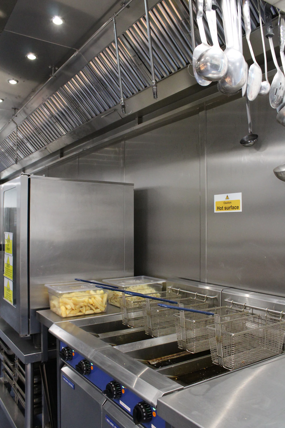 Commercial kitchen deep fryers needing grease exhaust cleaning in Abu Dhabi